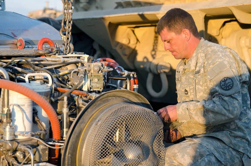 Sgt. 1st Class Paul Hussey, the tank mechanic section leader for F Company, 145th Brigade Support Battalion, 116th Heavy Brigade Combat Team, works on the engine of an Abrams M1A2 System Enhanced Package (SEP) Tank. (U.S. Army photo by 1st Sgt. Kevin Hartman, 115 Mobile Public Affairs Detachment, Oregon Army National Guard)