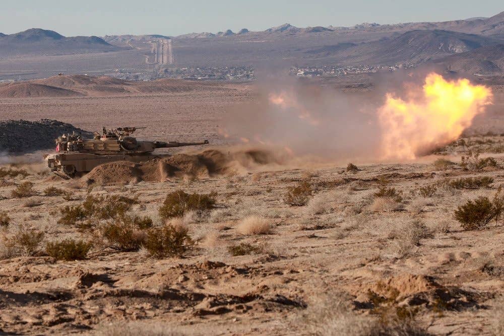 A U.S. Army M1A2 Abrams tank assigned to 3rd Armored Brigade Combat Team, 1st Cavalry Division, Fort Hood, Texas, fires its main weapon at targets while conducting live-fire exercises during Decisive Action Rotation 19-03 at the National Training Center (NTC), Fort Irwin, Calif. (U.S. Army photo by Pvt. Brooke Davis, Operations Group, National Training Center)