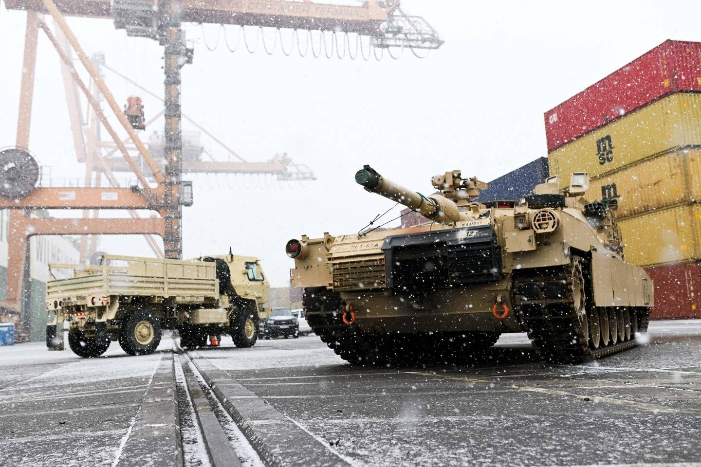 A M1A2 Abrams battle tank of the U.S. army that will be used for military exercises by the 2nd Armored Brigade Combat Team, is unloaded at the Baltic Container Terminal in Gdynia on December 3, 2022. (Photo by MATEUSZ SLODKOWSKI / AFP) (Photo by MATEUSZ SLODKOWSKI/AFP via Getty Images)