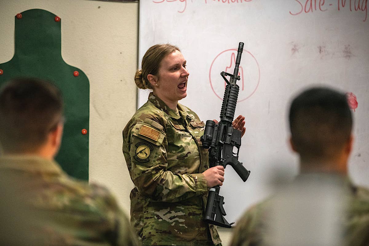U.S. Air Force Staff Sgt. Sara Riddle, 60th Security Forces combat arms instructor, gives a care and safety lesson about the M4 carbine at Travis Air Force Base, California, on January 18, 2023. <em>USAF / Nicholas Pilch</em>