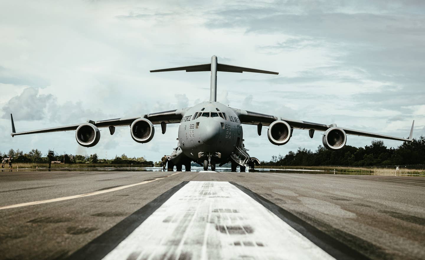 A U.S. Air Force C-17 Globemaster III, transporting personnel and equipment in support of Valiant Shield 22, lands on Palau, June 10, 2022. Exercises such as Valiant Shield allows the Indo-Pacific Command Joint Forces the opportunity to integrate forces from all branches of service to conduct precise, lethal, and overwhelming multi-axis, multi-domain effects that demonstrate the strength and versatility of the Joint Force and our commitment to a free and open Indo-Pacific. (U.S. Marine Corps photo by Cpl. Samuel Fletcher)