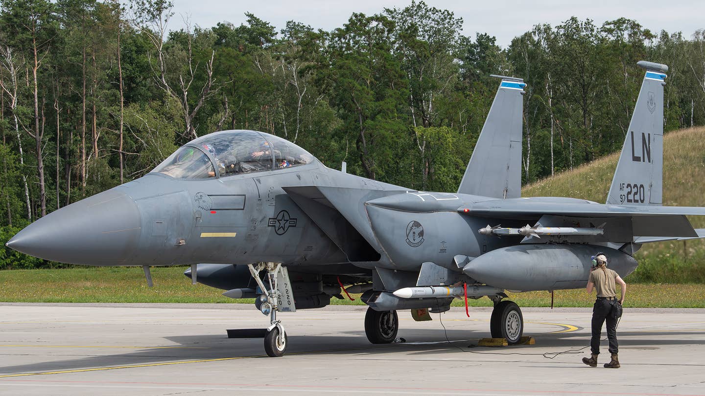 A 492nd FS F-15E at Łask Air Base, Poland, supporting NATO Air Shielding efforts in 2022 carrying live AMRAAMs on its CFT stations. <em>USAF/SSgt Danielle Sukhlall</em>