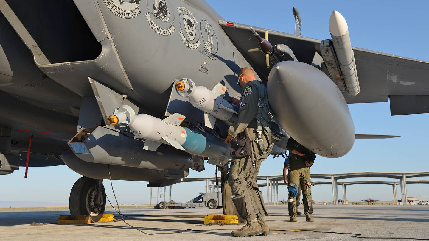 A close-up view of GBU-12 bombs loaded on the F-15E's CFTs, with the Sniper targeting pod on station 5A. <em>Jamie Hunter</em>