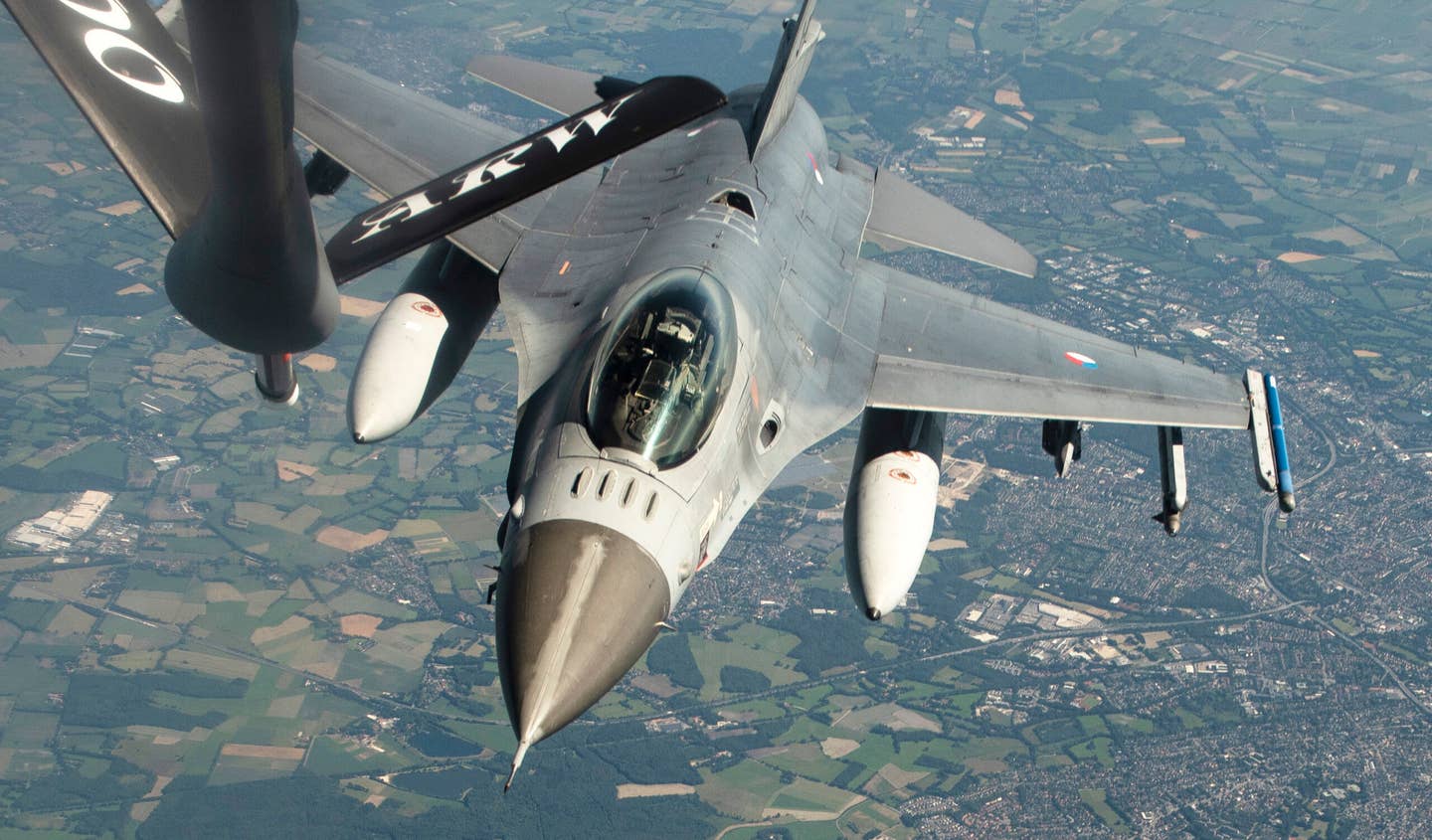 A Royal Netherlands Air Force F-16 approaches a U.S. Air Force KC-135 Stratotanker for refueling during a NATO exercise over Germany in 2020. <em>U.S. Air Force photo by Airman 1st Class Jessi Monte</em>