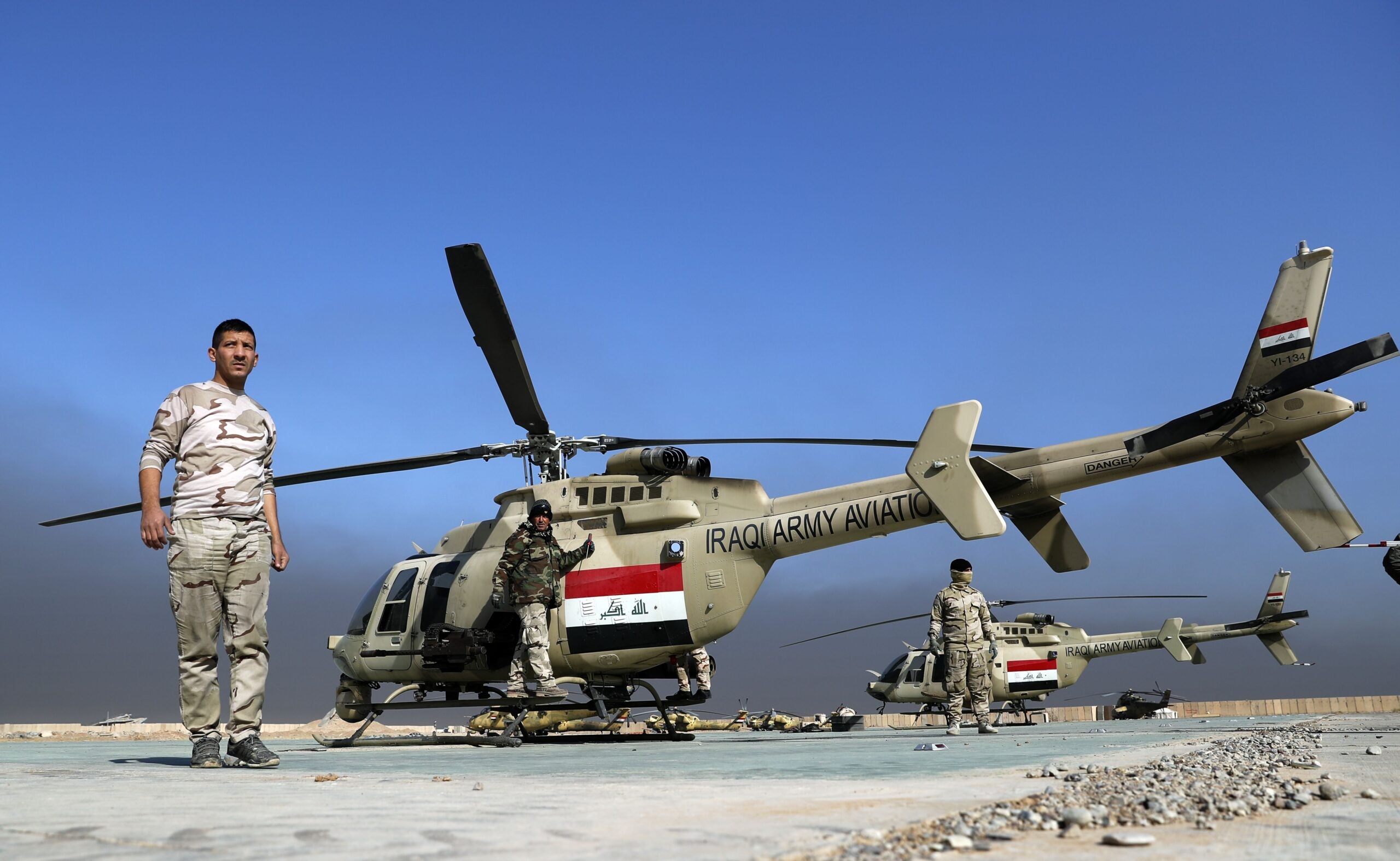 TOPSHOT - Iraqi soldiers perform maintenance on an airforce Bell 407 helicopter at the army base of Qaryat Jaddalat, south of the city of Mosul on November 25, 2016, during a massive operation to oust IS jihadists from the country's second city.  / AFP / THOMAS COEX        (Photo credit should read THOMAS COEX/AFP via Getty Images)
