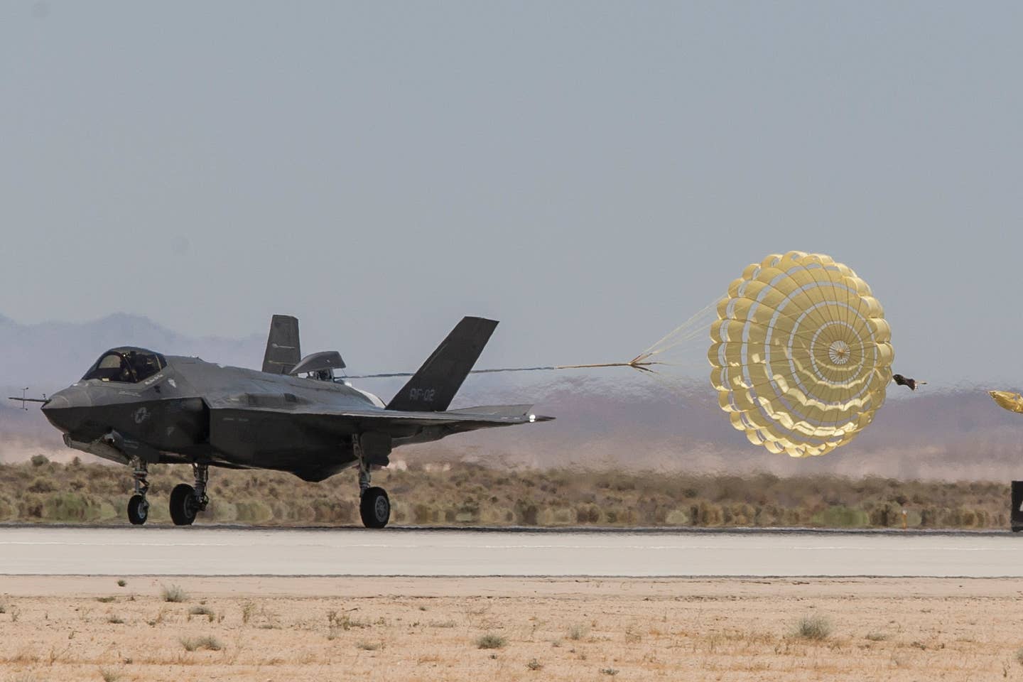One of the F-35A prototypes, modified with the drag chute, deploys it upon landing during early tests at Edwards Air Force Base, California. <em>Lockheed Martin photo by Jonathan Case</em><br>