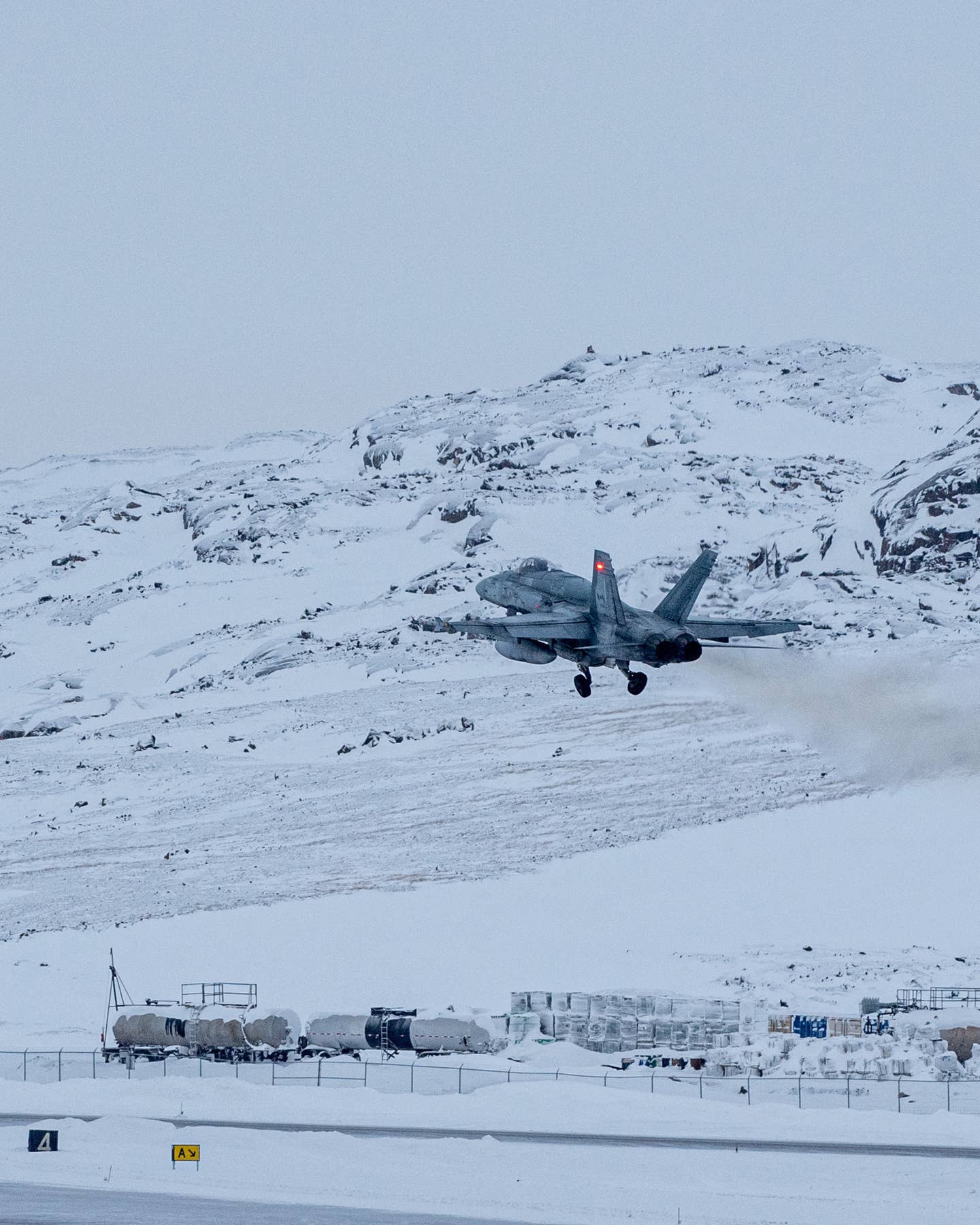 A Royal Canadian Air Force CF-18 Hornet from 3 Wing Bagotville takes off from Iqaluit Airport during Operation Noble Defender in the Canadian Arctic region, Iqaluit, Nunavut, Canada, Jan. 27, 2023. <em>Canadian NORAD Region Public Affairs</em>