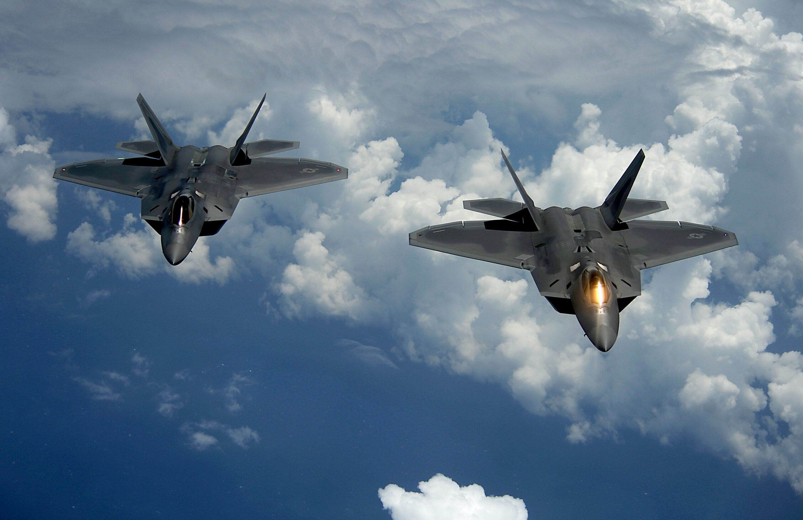 A pair of 1st Fighter Wing's F-22 Raptors from Joint Base Langley-Eustis, Va., pulls away and flies behind a KC-135 Stratotanker with the 756th Air Refueling Squadron, Joint Base Andrews Naval Air Facility, Md. after receiving fuel off the east coast on July 10, 2012. The first Raptor assigned to the Wing arrived Jan. 7, 2005. This aircraft was allocated as a trainer, and was docked in a hanger for maintenance personnel to familiarize themselves with its complex systems. The second Raptor, designated for flying operations, arrived Jan. 18, 2005. On Dec. 15, 2005, Air Combat Command commander, along with the 1st FW commander, announced the 27th Fighter Squadron as fully operational capable to fly, fight and win with the F-22.