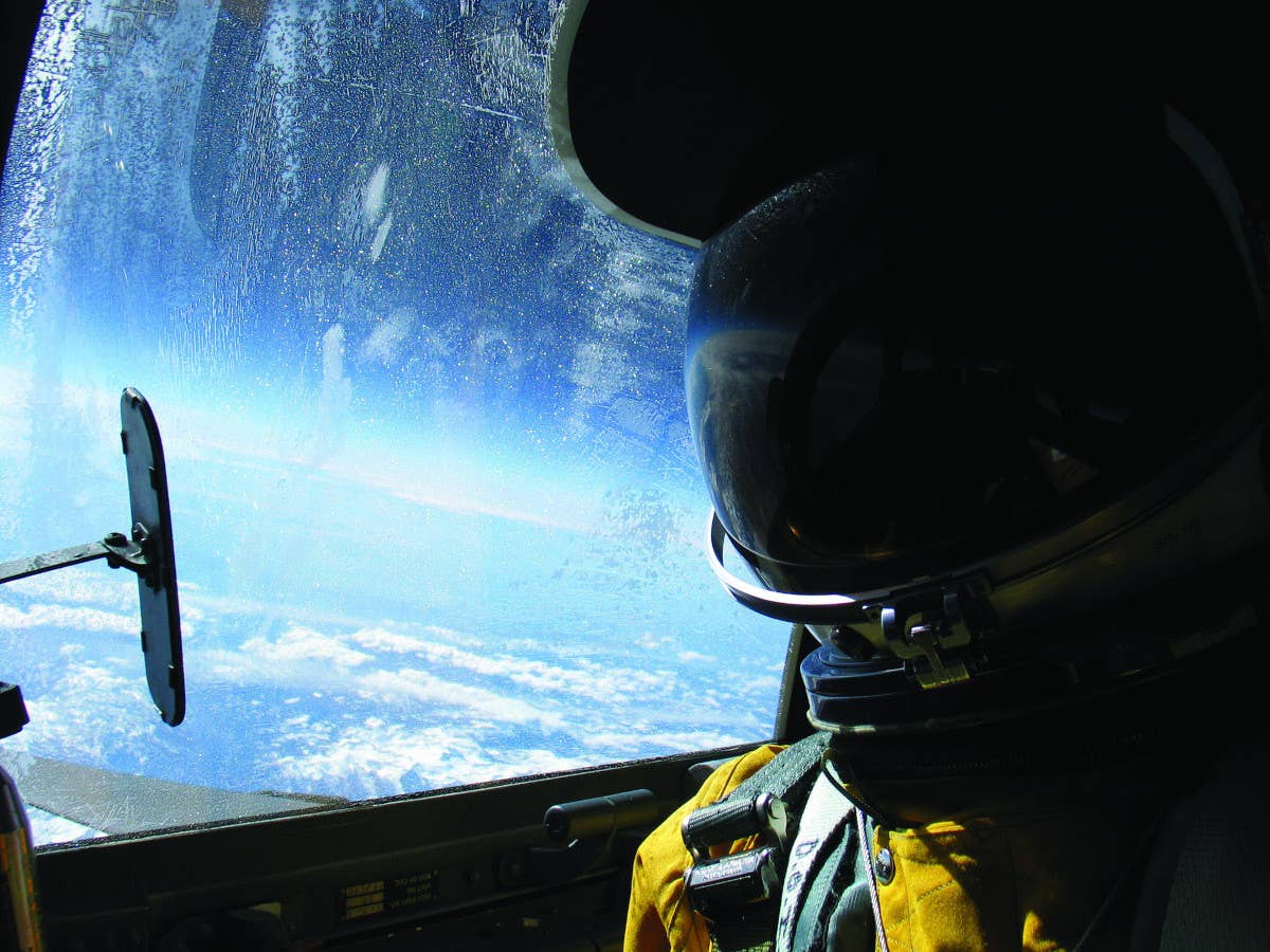 A view from the cockpit of a U-2 flying at 71,000 feet. Note the pilot's flight suit is more akin to a space suit due to the altitudes at which the Dragon Lady typically flies. <em>USAF</em>