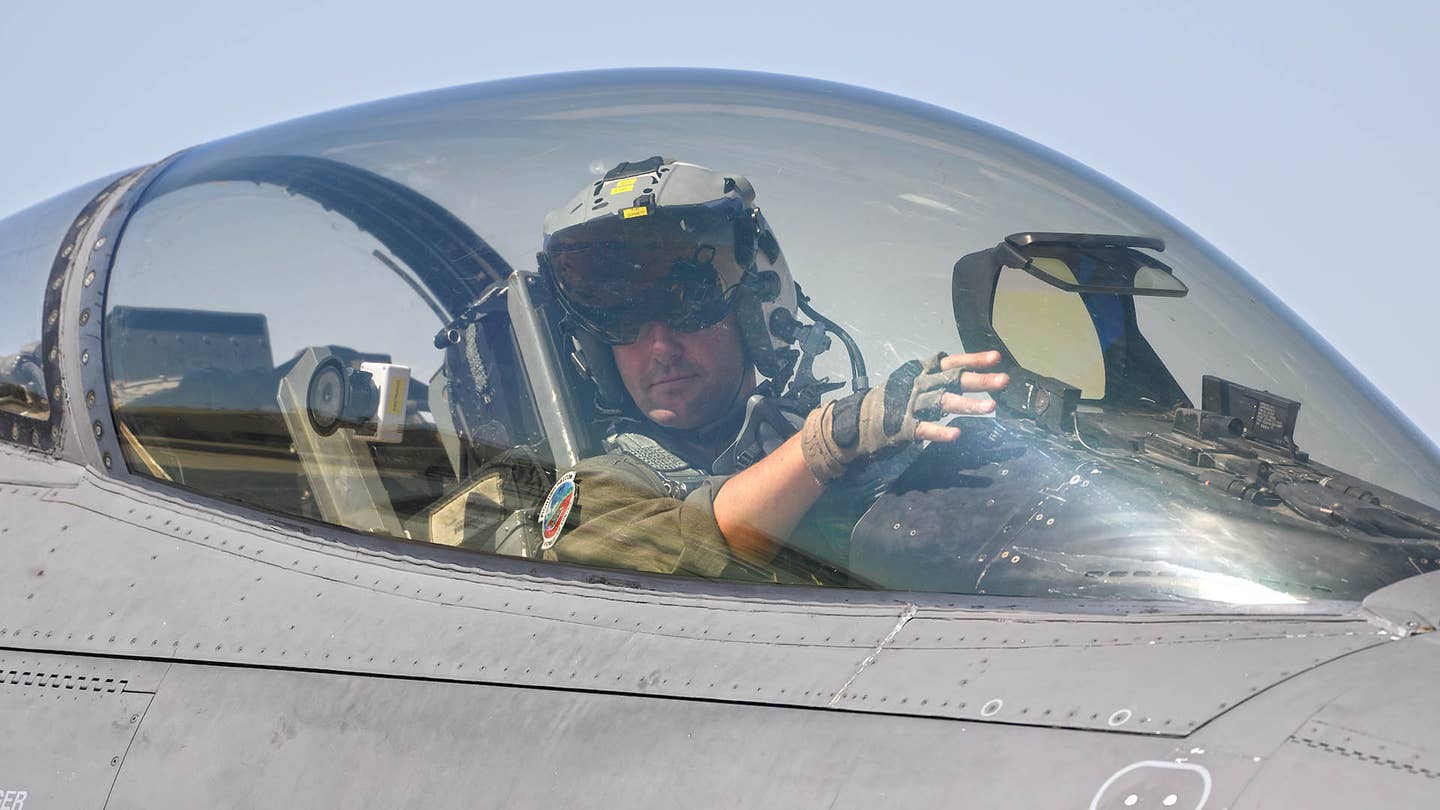 An F-16 pilot wearing the Joint Helmet-Mounted Cueing System. <em>Jamie Hunter</em>