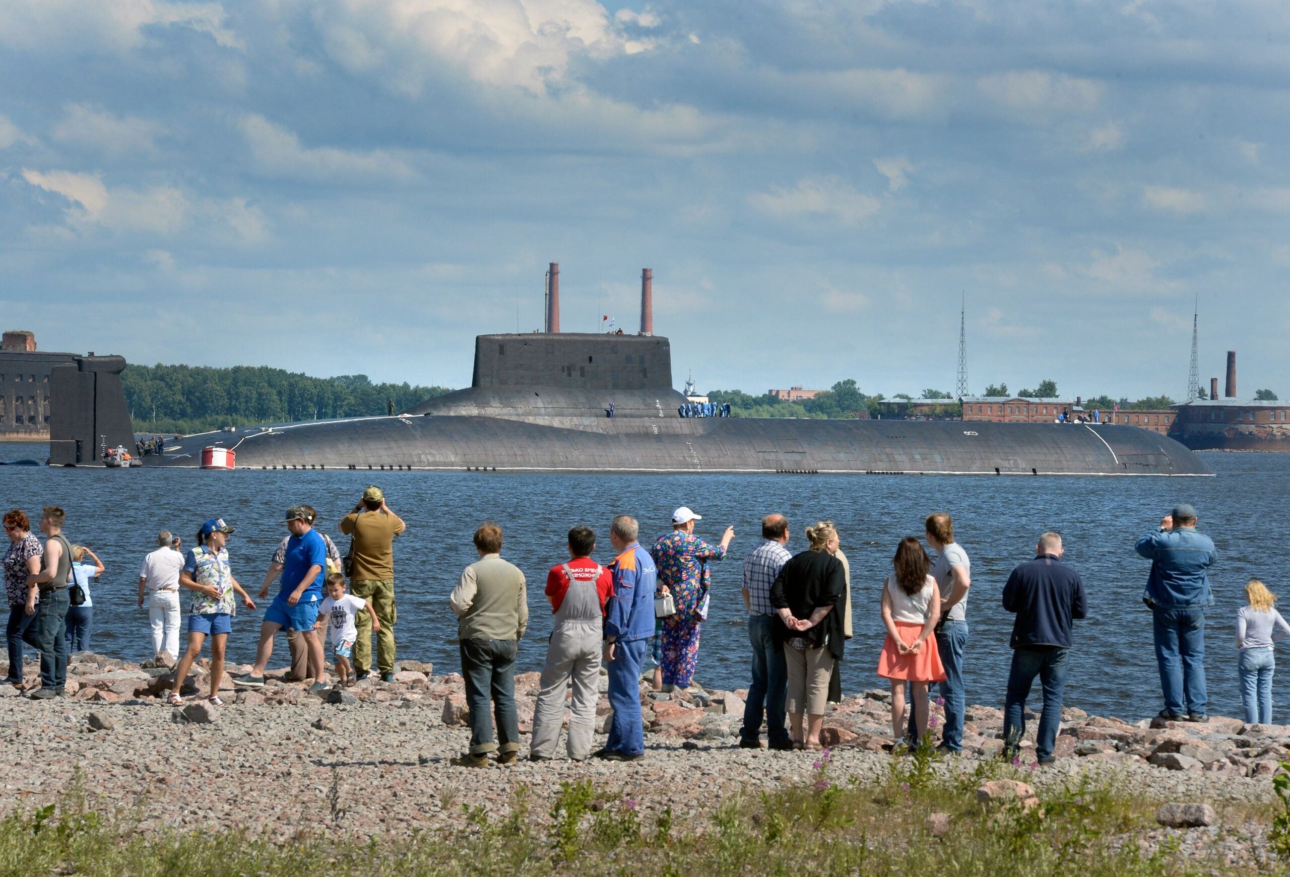 People watch as the Russian submarine Dmitry Donskoy (NATO - Typhoon class), the world's largest in active service, arrives at Kronstadt Navy base, outside Saint Petersburg, on July 26, 2017 to take part in the Naval Military Parade. 
The Naval Military Parade will be held in Saint Petersburg on Navy Day, July 30. / AFP PHOTO / OLGA MALTSEVA        (Photo credit should read OLGA MALTSEVA/AFP via Getty Images)