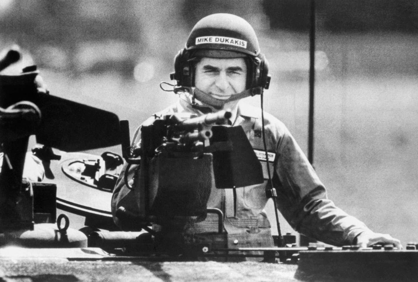 Then-presidential candidate, Mike Dukakis, wearing an army tanker's helmet, peers behind the loader's weapon of an MIAI Abrams Main Battle Tank during a demonstration ride in 1988. He <a href="https://www.270towin.com/1988_Election/">lost in a landslide</a> to George H. W. Bush, by a 426-111 Electoral College vote margin. (Getty Images photo).