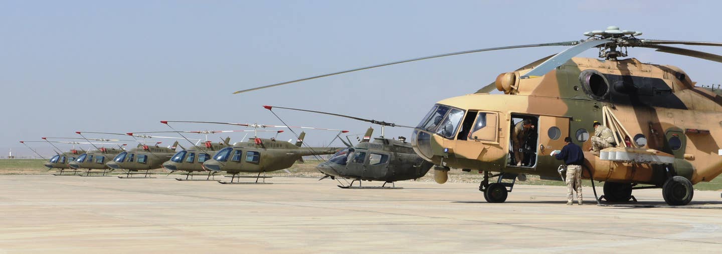 An Iraqi Army Mi-17, at right, alongside five Bell 206 Jet Rangers and an OH-58C Kiowa used as trainers. <em>U.S. Army</em>