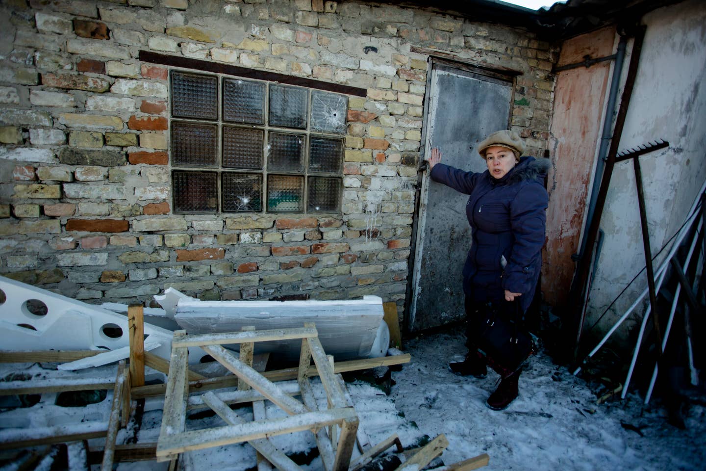 A local woman shows the broken glass in her garage on February 10, 2023, in Kyiv. (Photo by Yan Dobronosov/Global Images Ukraine via Getty Images)