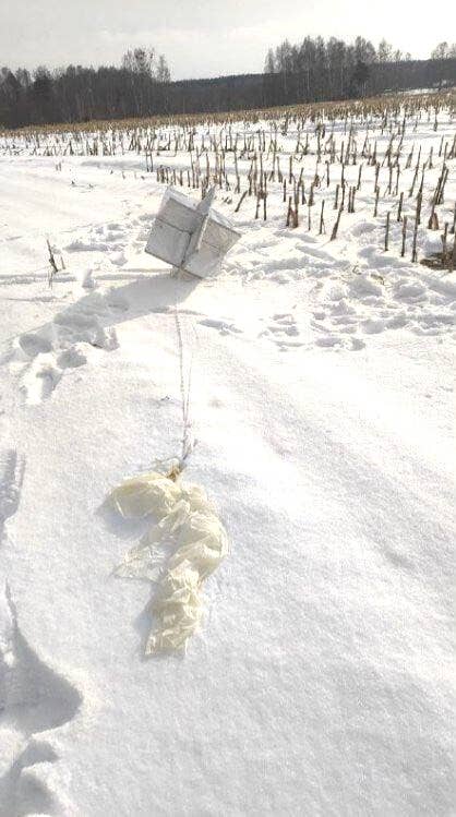 One of the balloons that was shot down over Kyiv airspace in February 2023. The remains of the balloon's envelope is visible in the foreground and what looks to be a radar reflector is seen behind connected via some kind of line. (Courtesy photo)