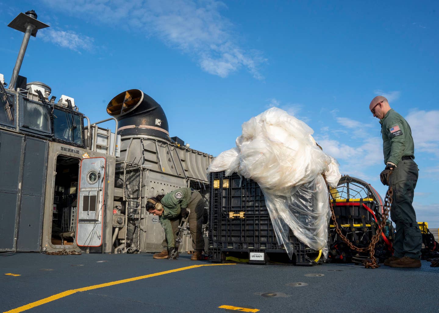 VIRGINIA BEACH, Va.– Sailors assigned to Assault Craft Unit 4 prepare material recovered in the Atlantic Ocean from a high-altitude balloon for transport to federal agents at Joint Expeditionary Base Little Creek, Feb. 10, 2023. <em>U.S. Navy photo by Mass Communication Specialist 1st Class Ryan Seelbach</em>