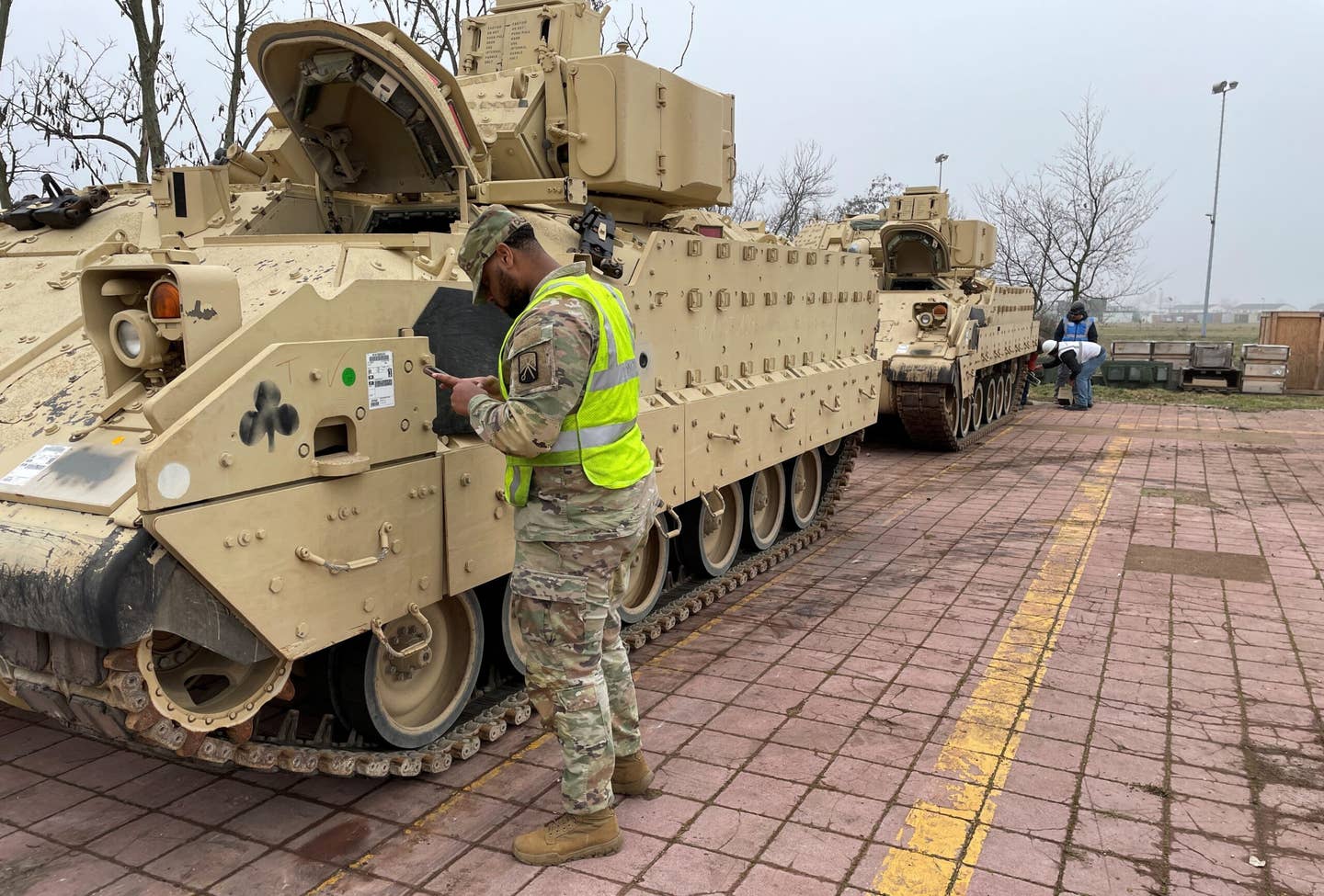 A soldier from the 624th Transportation Detachment (Movement Control), 39th Transportation Battalion, 16th Sustainment Brigade, gathers vehicle information from an M2A2 Bradley that recently arrived at the Coleman Army Prepositioned Stocks-2 worksite in Mannheim, Germany. <em>U.S. Army/Photo by Jason Todd</em>