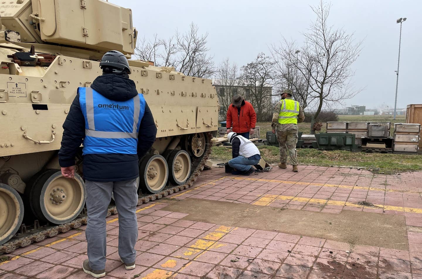 Employees and contractors from Army Field Support Battalion-Mannheim’s Coleman Army Prepositioned Stocks-2 worksite verify information on an M2A2 Bradley sent to Europe. <em>U.S. Army/Photo by Jason Todd</em>