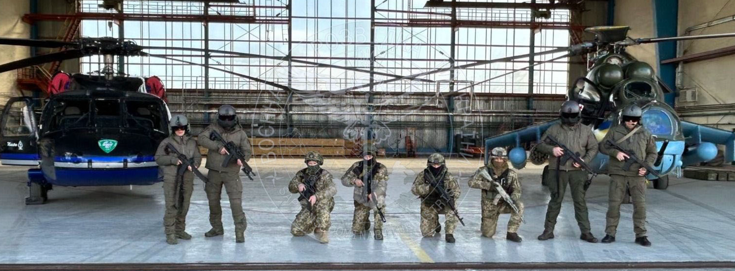 The newly identified Black Hawk and a Mi-24, plus Main Directorate of Intelligence soldiers, in a hangar somewhere in Ukraine. <em>Main Directorate of Intelligence of the Ministry of Defense of Ukraine</em>