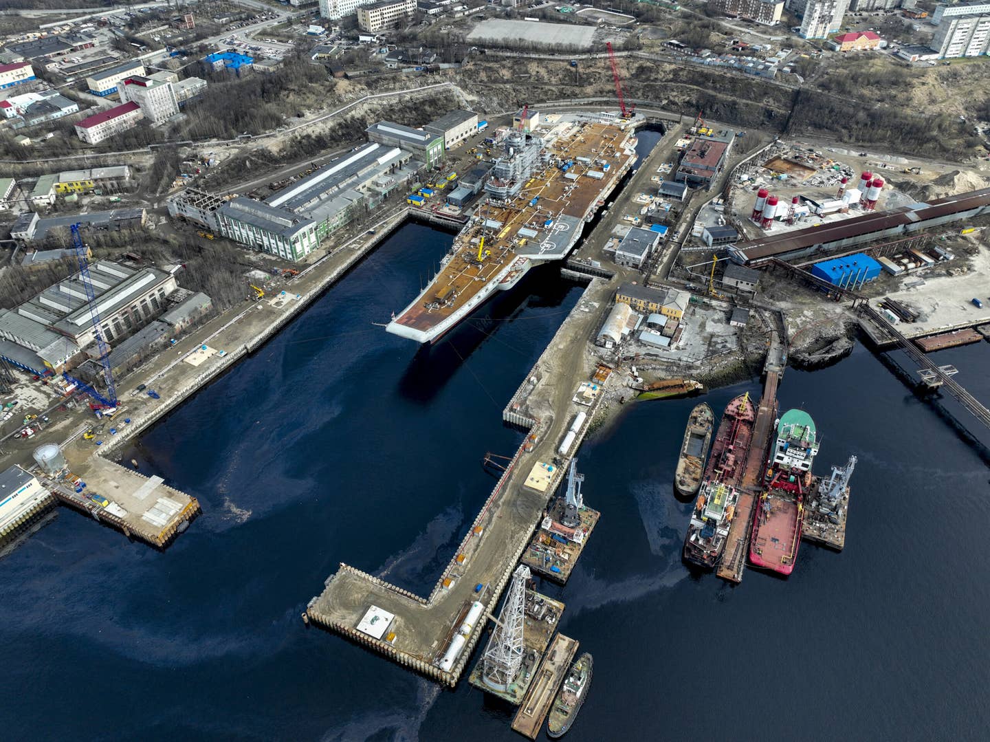 Russia's lone aircraft carrier is towed to the 35th squadron shipyard for maintenance and repair works in Murmansk, Russia on May 20, 2022. <em>Credit: Photo by Semen Vasileyev/Anadolu Agency via Getty Images</em>