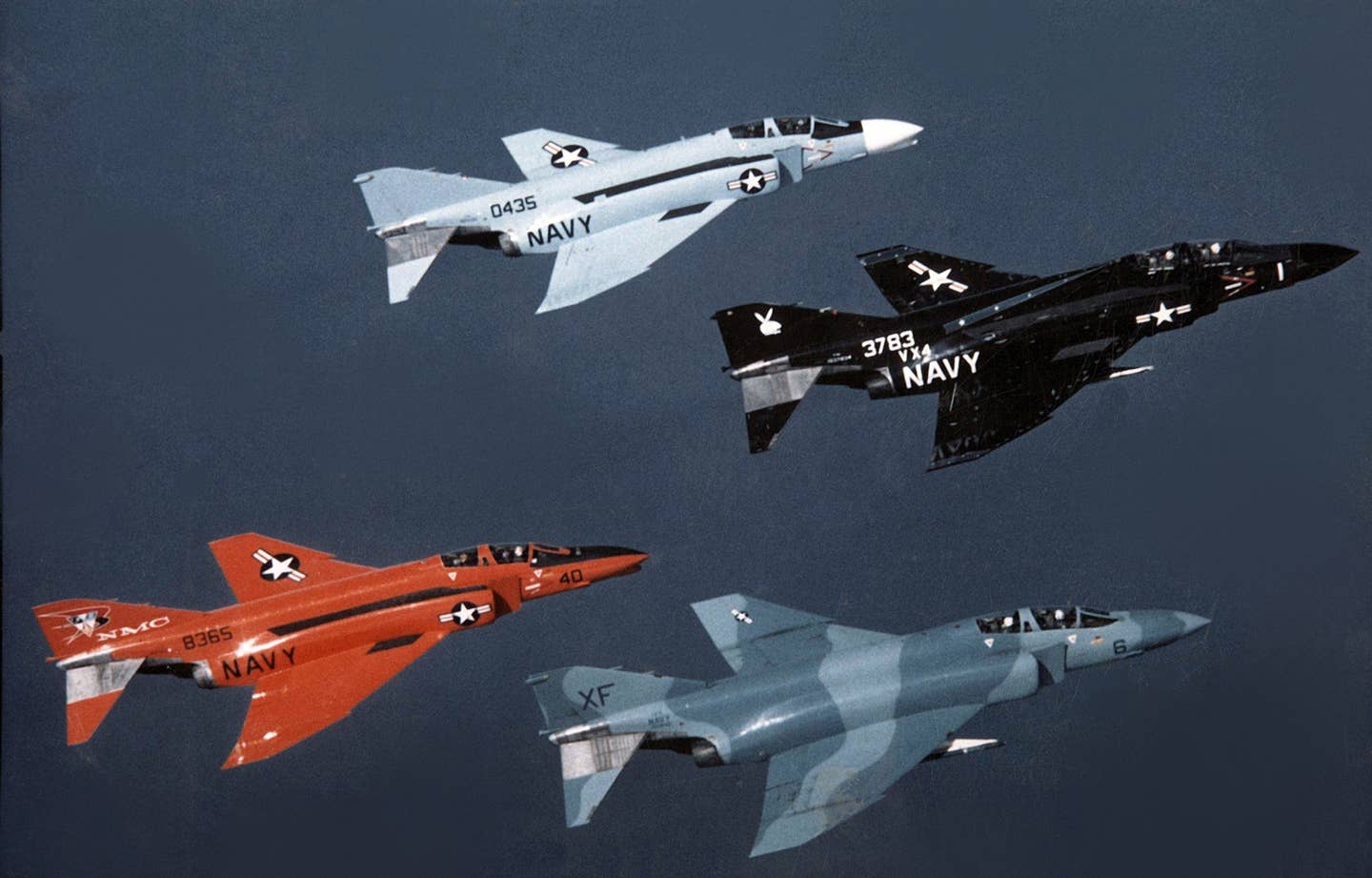 A formation of F-4s from VX-4 including a QF-4B, F-4B, and two F-4Js. <em>U.S. Navy National Museum of Aviation</em>