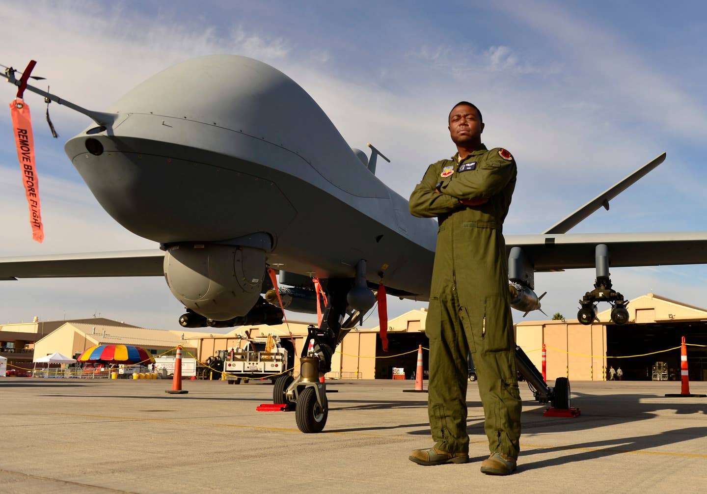 Staff Sgt. Kenneth, 432nd Wing MQ-9 sensor operator, stands in front of an MQ-9 Reaper during Aviation Nation Nov. 11, 2016. <em>Credit: U.S. Air Force photo by Senior Airman Christian Clausen</em>