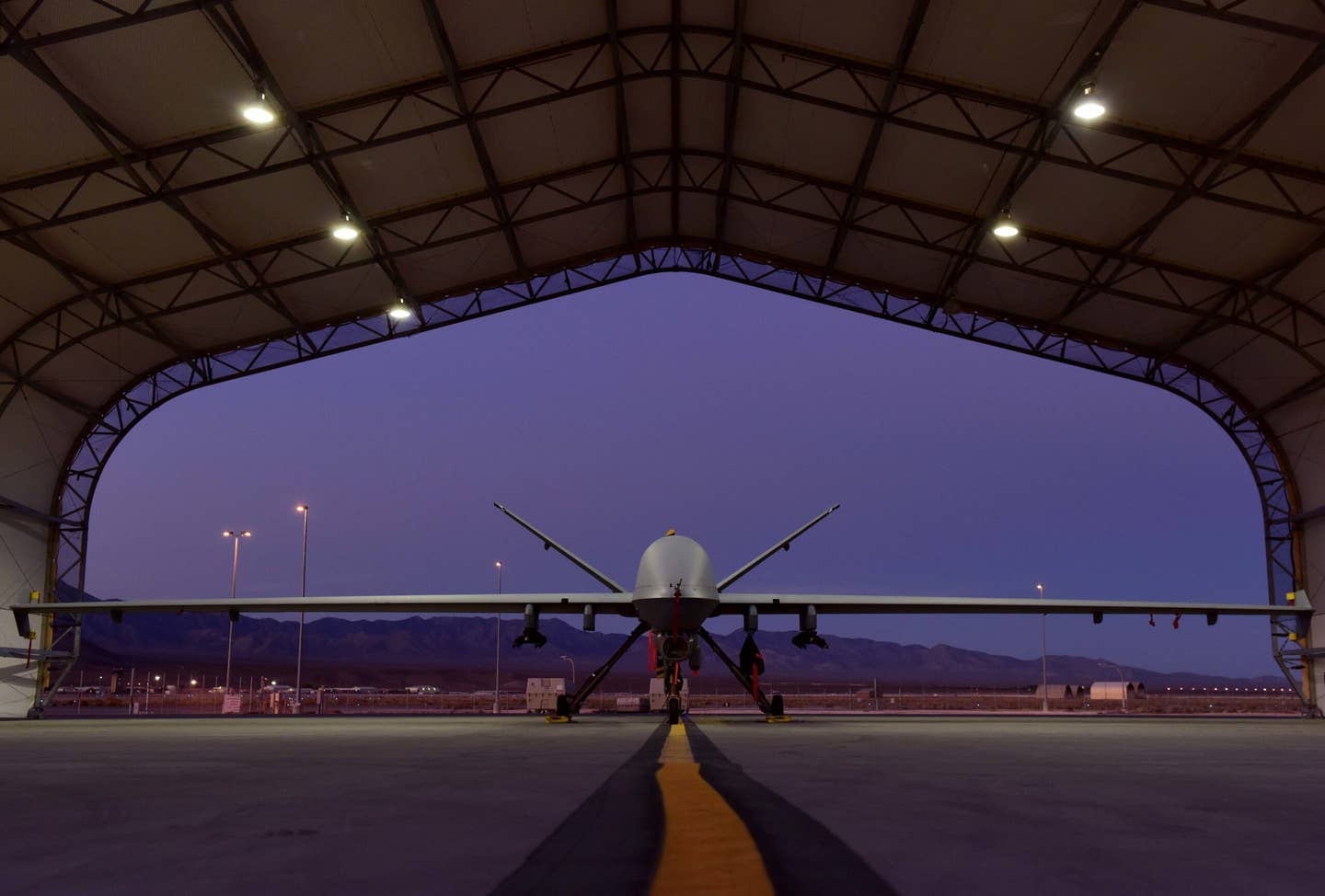 An MQ-9 Reaper sits under a sunshade in the early morning at Creech Air Force Base, Nevada, Oct. 25, 2019. <em>Credit: U.S. Air Force photo by Senior Airman Haley Stevens</em>