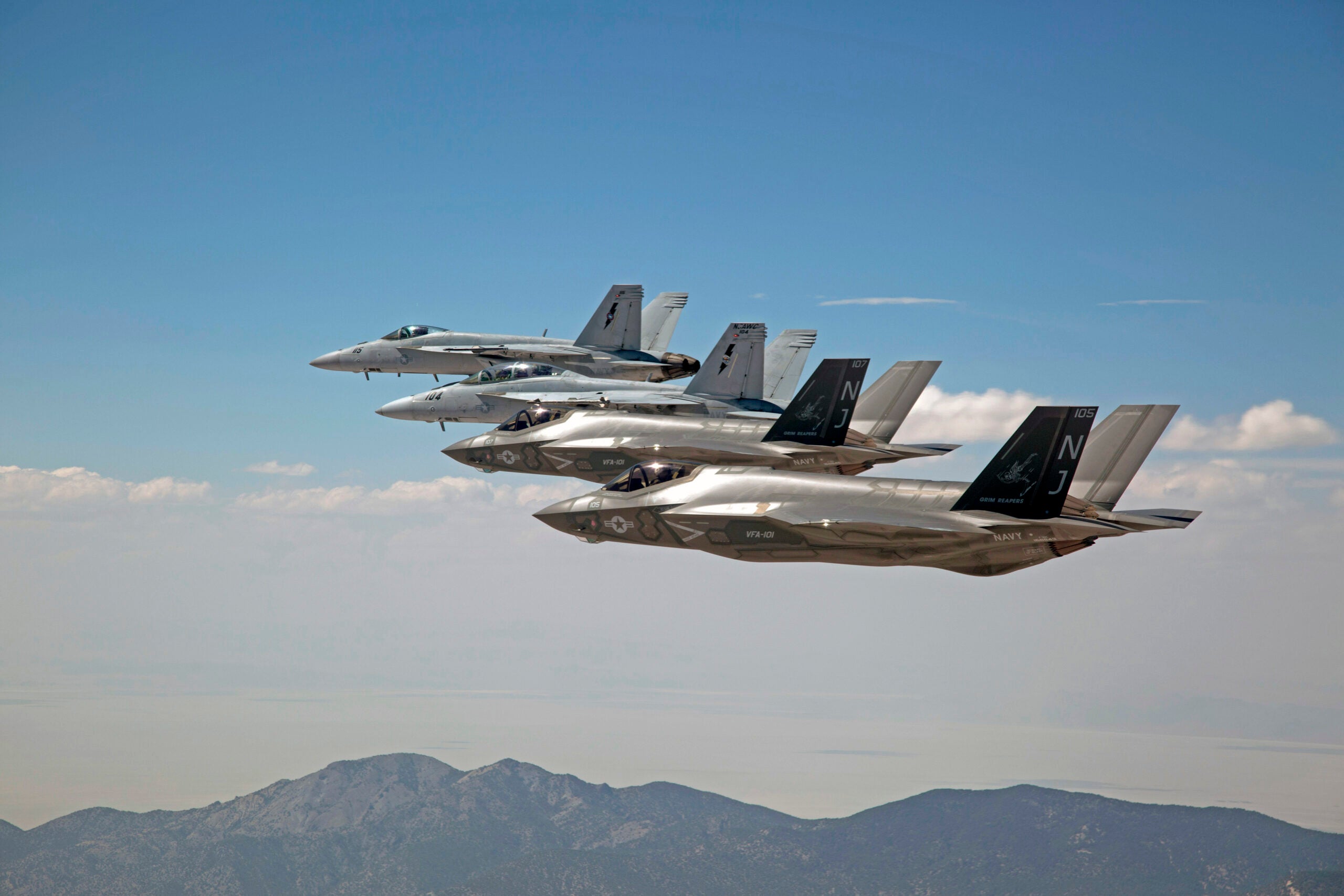 150903-N-SS390-354 
FALLON, Nev. (Sept. 3, 2015) F-35C Lightning IIs, assigned to the Grim Reapers of Strike Fighter Squadron (VFA) 101, and an F/A-18E/F Super Hornets assigned to the Naval Aviation Warfighter Development Center (NAWDC) fly over Naval Air Station Fallon's (NASF) Range Training Complex. VFA 101, based out of Eglin Air Force Base, is conducting an F-35C cross-country visit to NASF.  The purpose is to begin integration of F-35C with the Fallon Range Training Complex and work with NAWDC to refine tactics, techniques and procedures (TTP) of F-35C as it integrates into the carrier air wing. (U.S. Navy photo by Lt. Cmdr. Darin Russell/Released)