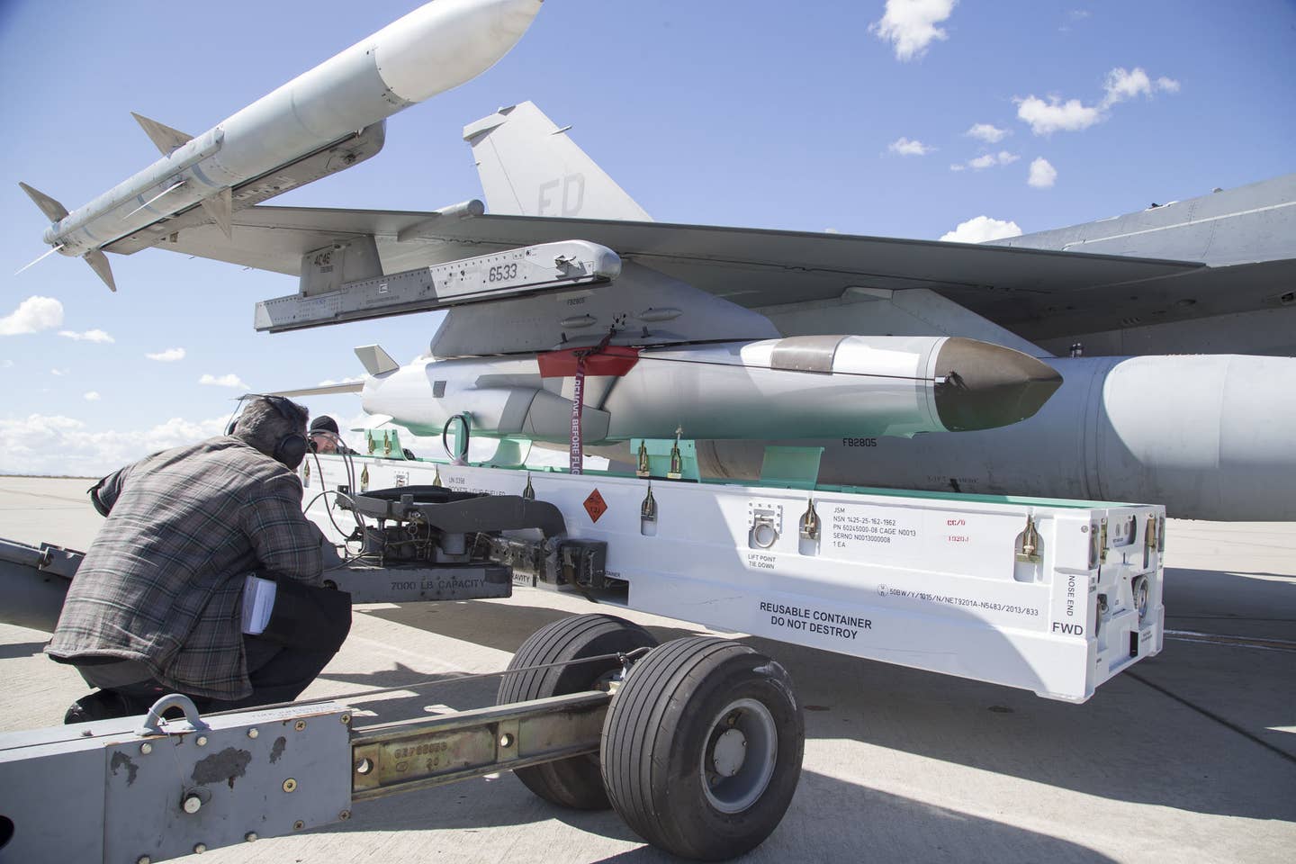 A Joint Strike Missile is loaded onto a U.S. Air Force F-16 Viper fighter jet during a test. <em>USAF</em>