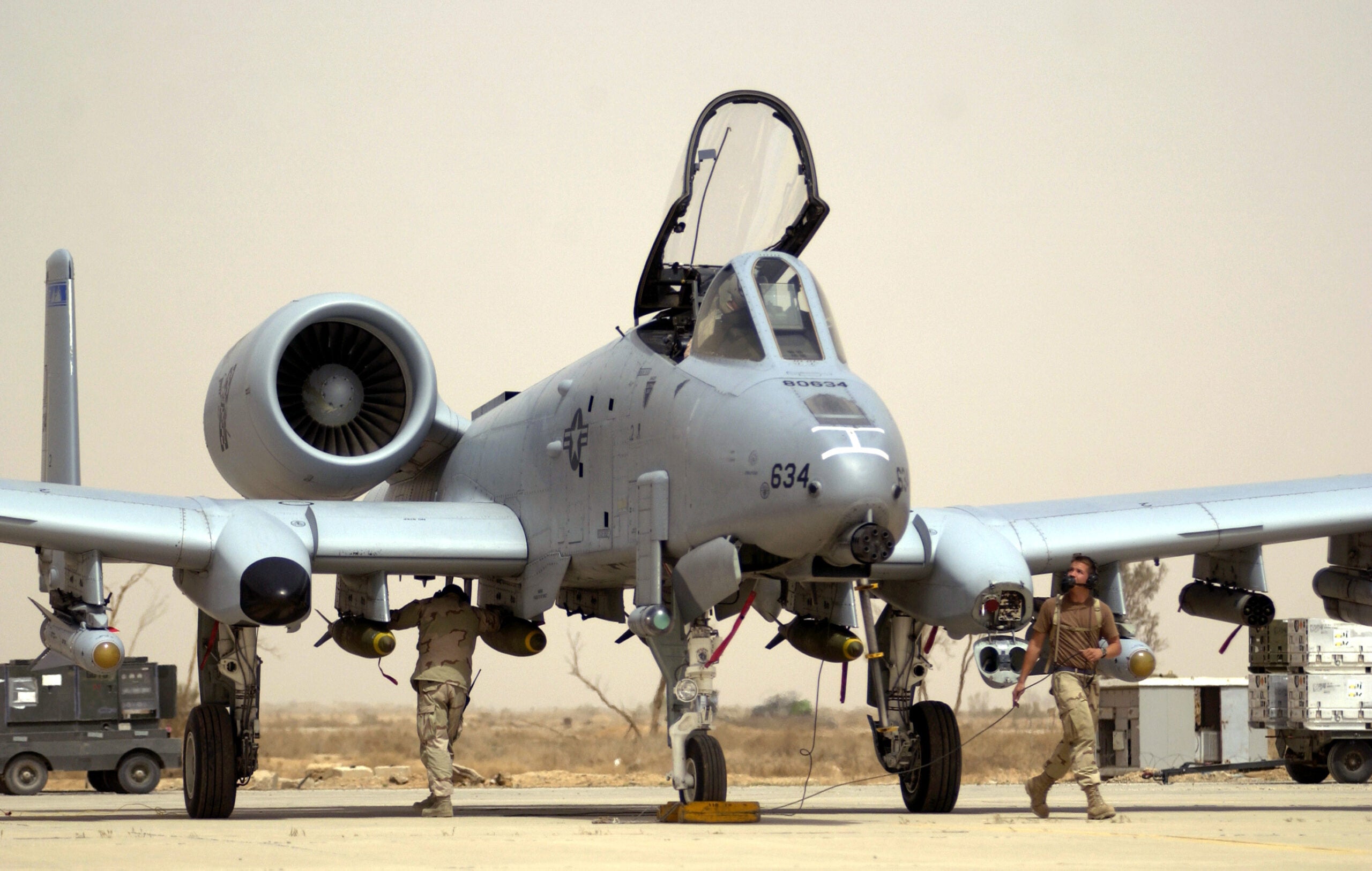 OPERATION IRAQI FREEDOM  --  Crew chiefs with the 392nd Air Expeditionary Wing conduct pre-flight checks on an A-10 Thunderbolt II at a forward-deployed location supporting Operation Iraqi Freedom.  A-10s have been operating at an air base in southern Iraq for about a week, giving them more time over the battlefield because they expend less fuel getting to and from the front.  (U.S. Air Force photo by Staff Sgt. Shane A. Cuomo)