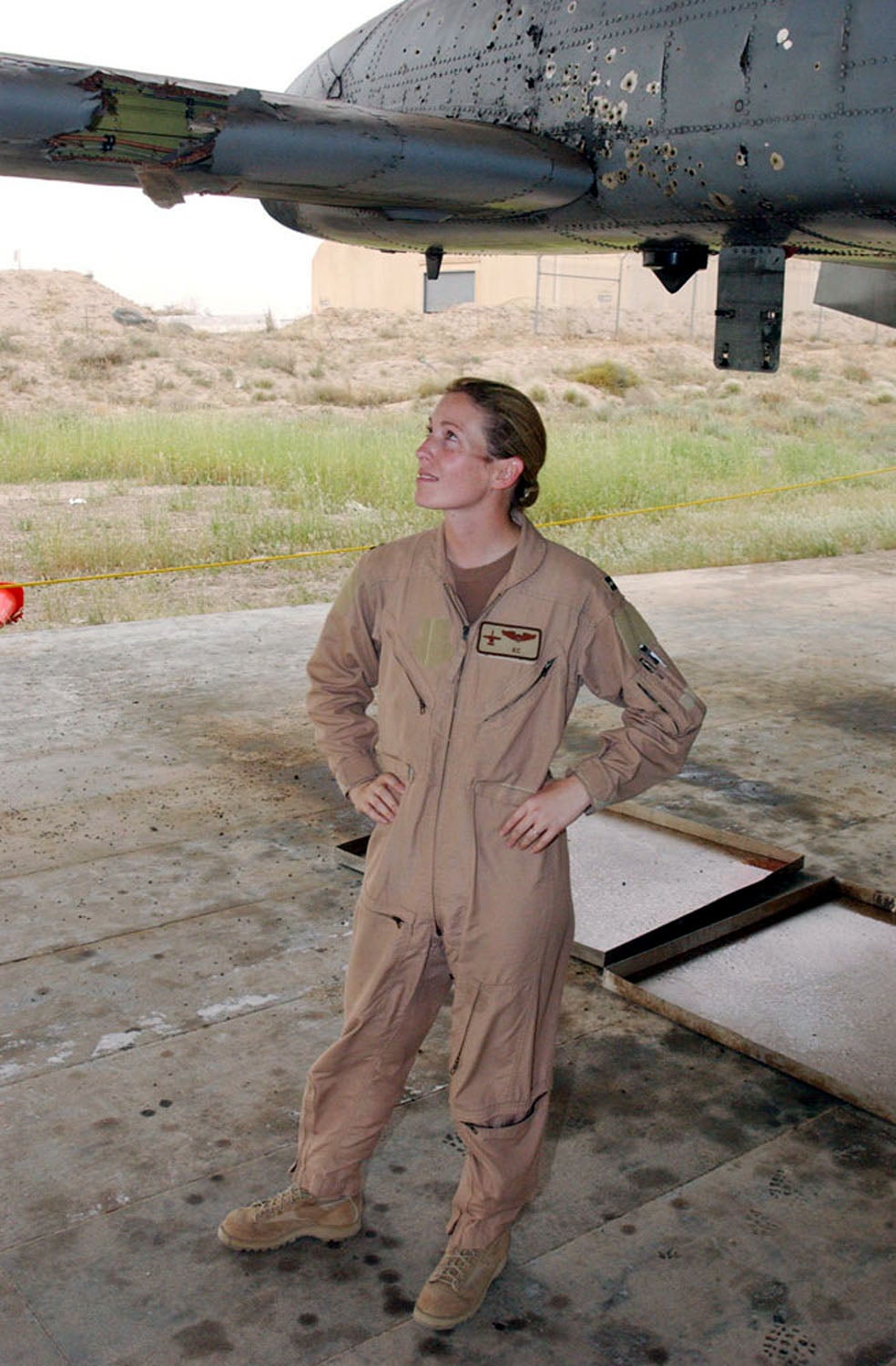 Then Capt. Kim Campbell, an A-10 Thunderbolt II pilot deployed with the 332nd Air Expeditionary Wing, surveys the battle damage to her airplane. Captain Kim's A-10 was hit over Baghdad during a close air support mission on April 7.  (Courtesy photo)