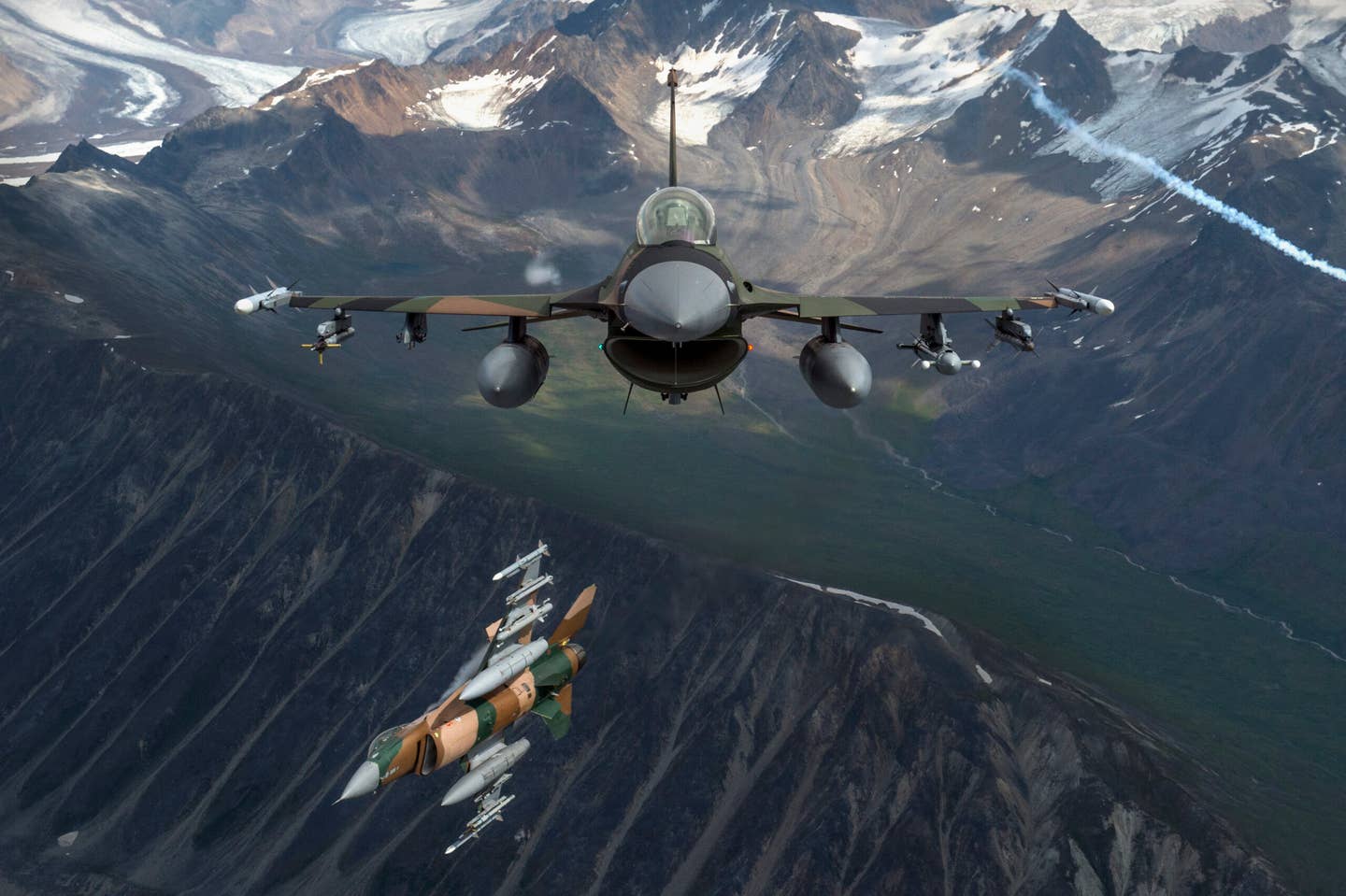 U.S. Air Force F-16 Fighting Falcons from Eielson Air Force Base fly in formation over the Joint Pacific Alaska Range Complex, July 18, 2019. The JPARC is a 67,000 plus square mile area, providing a realistic training environment commanders leverage for full spectrum engagements, ranging from individual skills to complex, large-scale joint engagements. (U.S. Air Force photo by Staff Sgt. James Richardson)