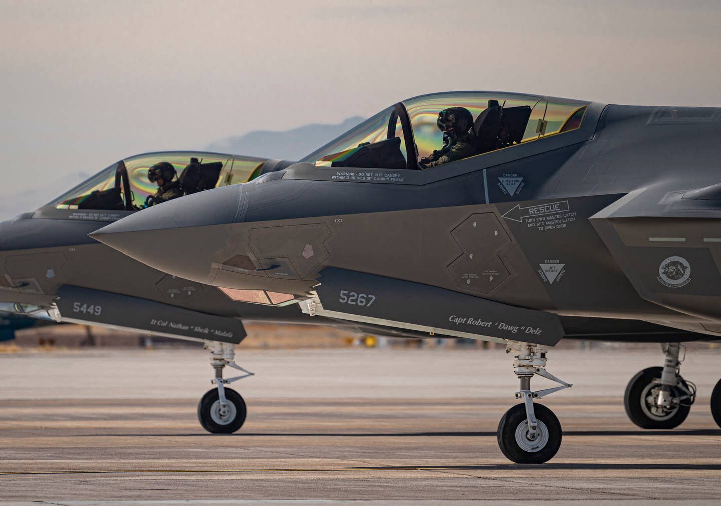 Two F-35A Lightning II fighter jets assigned to the 422nd Test and Evaluation Squadron (TES), wait to take off for a mission at Nellis Air Force Base, Nevada, Oct. 21, 2021. The 422nd TES is a geographically separated unit of the 53rd Test and Evaluation Group, Eglin AFB, Florida. (U.S. Air Force photo by William R. Lewis)