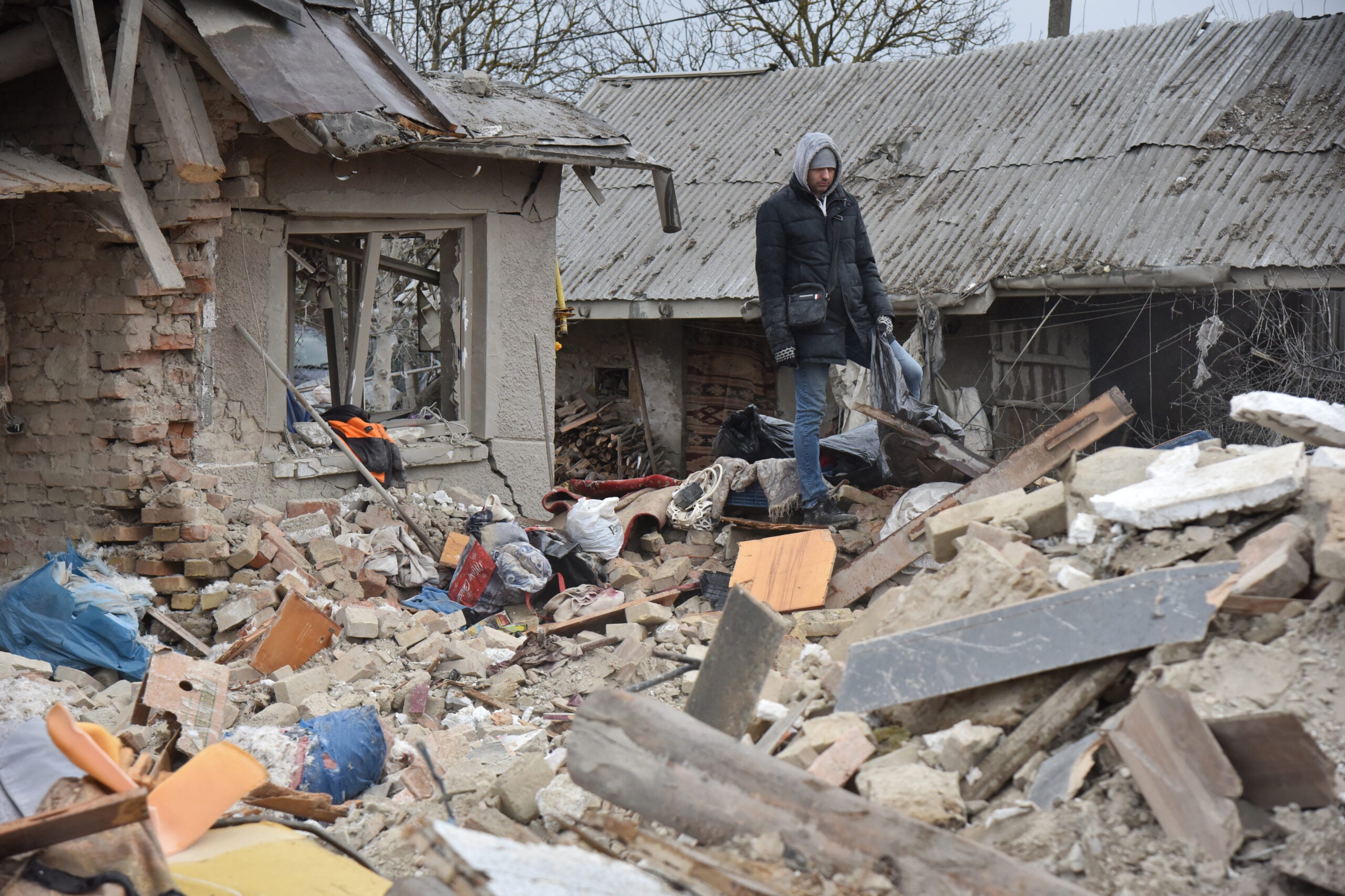LVIV, UKRAINE - MARCH 9: People disassemble houses destroyed by a Russian missile hitting a residential area in the village of Velika Vilshanytsia, Lviv Region, Ukraine on March 9, 2023. Tonight, a Russian missile hit two residential buildings, killing 5 adults. Nearby buildings and cars were also destroyed. (Photo by Pavlo Palamarchuk/Anadolu Agency via Getty Images)