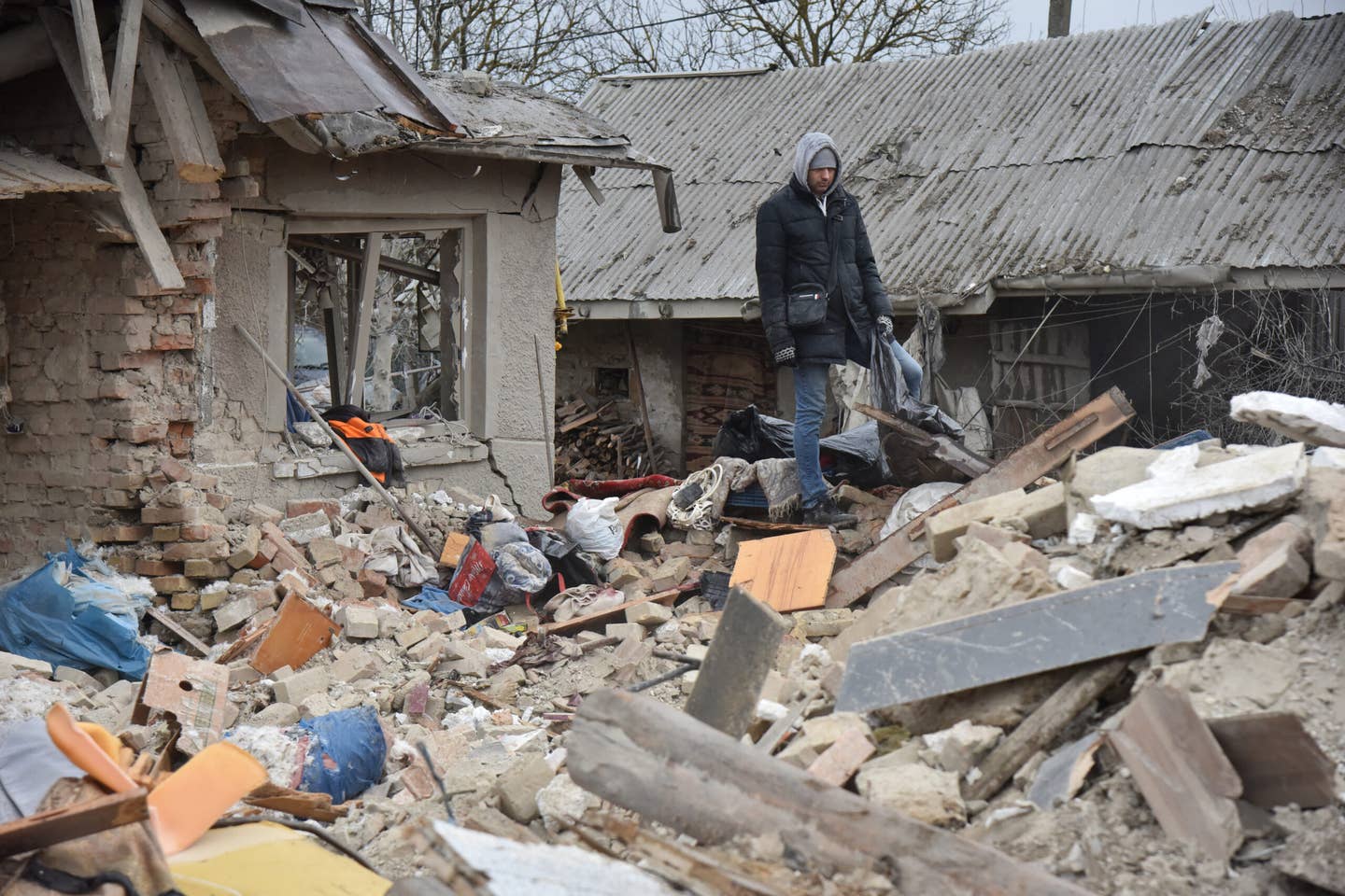 People disassemble houses destroyed by a Russian missile hitting a residential area in the village of Velika Vilshanytsia, Lviv Region, Ukraine on March 9, 2023. (Photo by Pavlo Palamarchuk/Anadolu Agency via Getty Images)