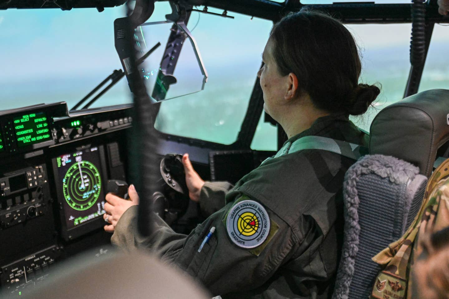 A 61st Airlift Squadron loadmaster gains familiarization with the C-130J flight control panels during simulator training at Little Rock Air Force Base, Arkansas, Feb. 16, 2023. <em>Credit: U.S. Air Force photo by Airman 1st Class Maria Umanzor Guzman</em>