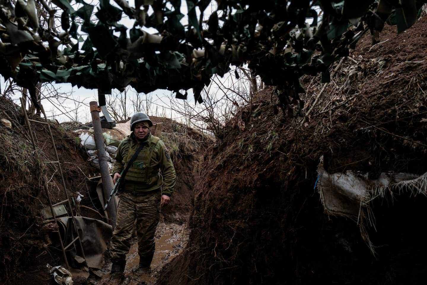 In a scene eerily reminiscent of World War One trench warfare, another soldier from the Ukrainian 24th Mechanized Brigade is seen south of Bakhmut, Ukraine. <em>Photo by Wolfgang  Schwan/Anadolu Agency via Getty Images</em>