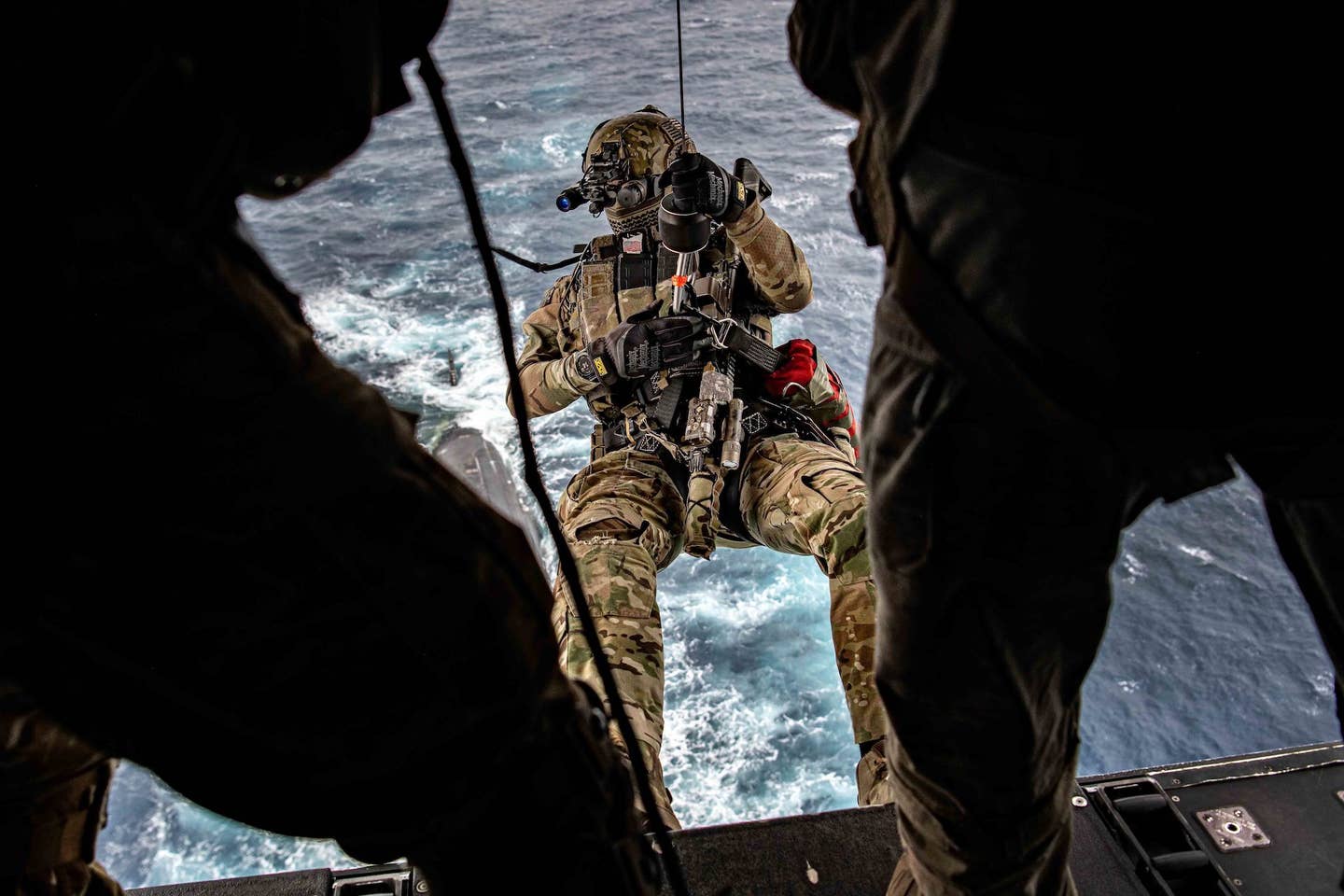 Navy SEAL winching down to USS <em>Florida</em>. <em><em>U.S. Air Force photo by Tech Sgt. Westin Warburton</em></em>