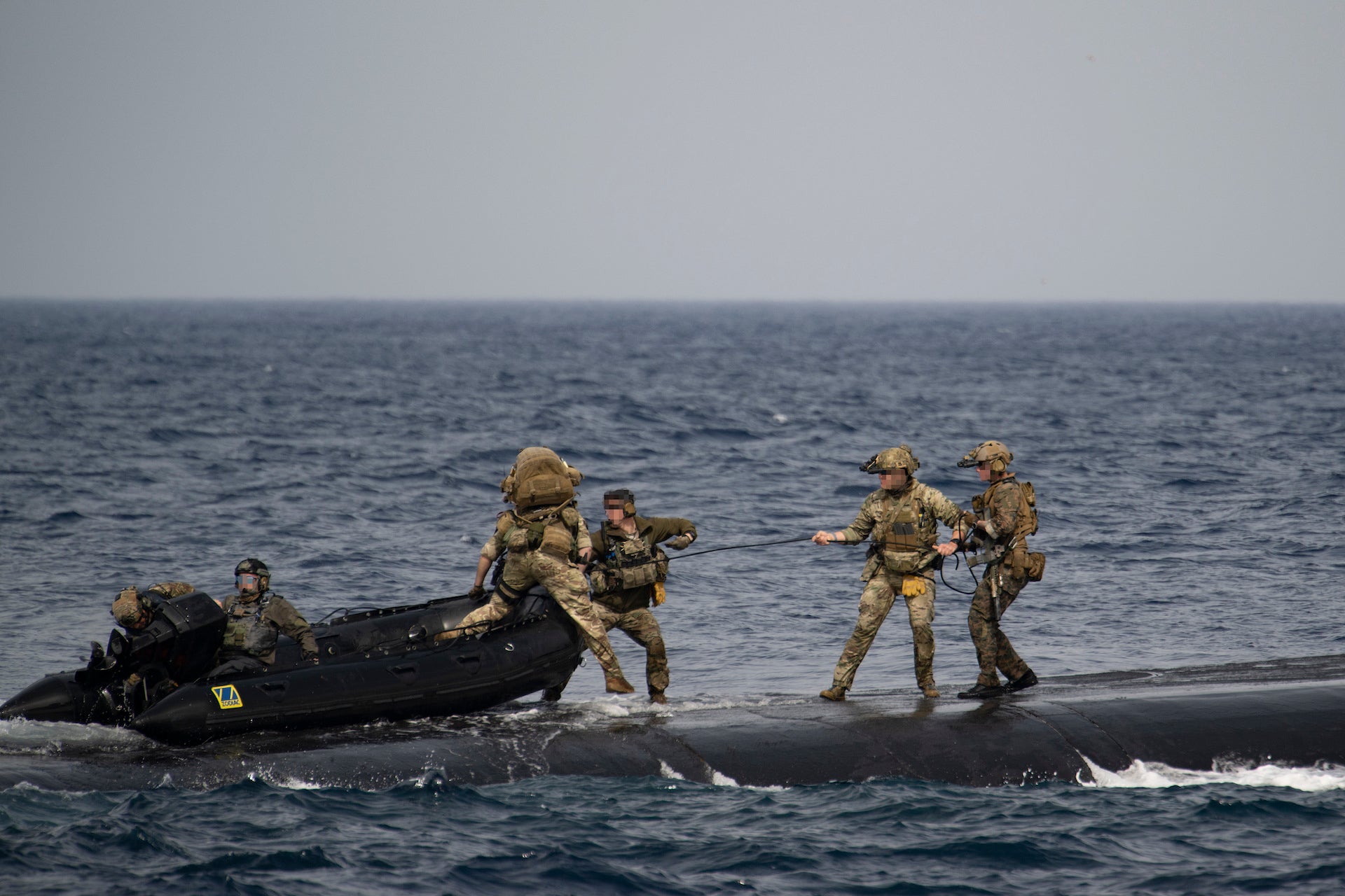 MEDITERRANEAN SEA (Feb. 27, 2023) East-Coast-based U.S. Naval Special Warfare Operators (SEALs) and NATO special operations forces partners land a combatant rubber raiding craft (CRRC) aboard Ohio-class guided-missile submarine USS Florida (SSGN 728) during a special operations forces interoperability exercise, Feb. 27, 2023. These  operations demonstrate U.S. European Command’s ability to rapidly deploy Special Operations Forces throughout the theater at a time and place of our choosing, and the U.S. commitment to train with Allies and partners to deploy and fight as multinational forces and SOF to meet today’s challenges. (U.S. Navy photo by Mass Communications Specialist 2nd Class Matthew Dickinson)