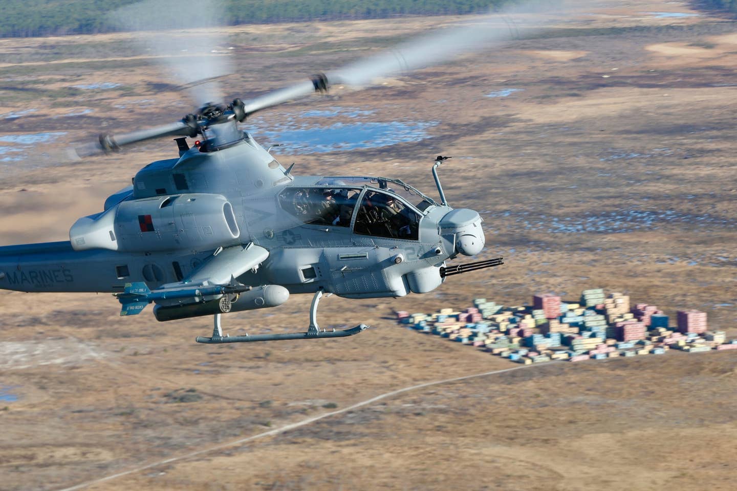 An AH-1Z over a MOUT training complex. (Author)