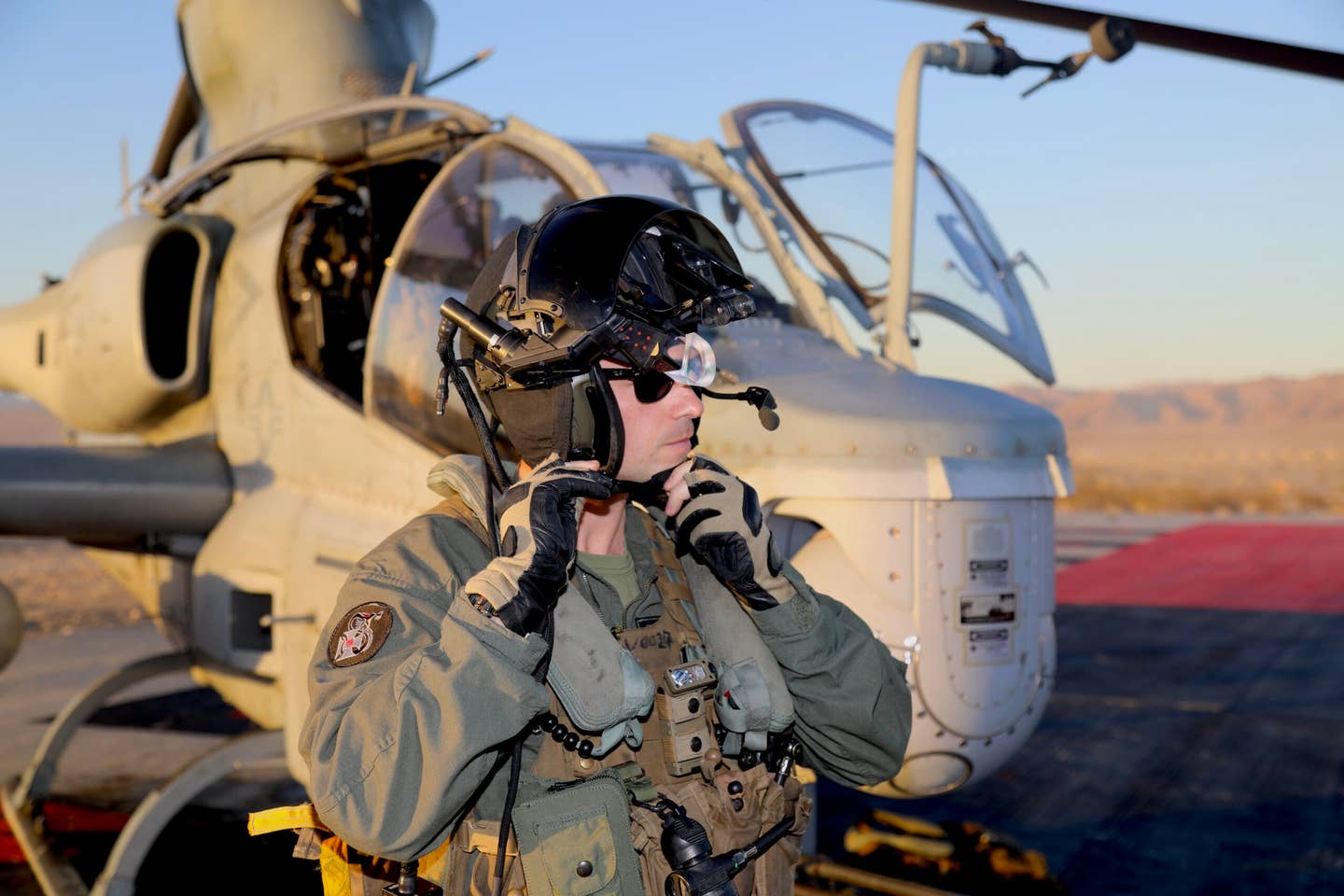 The AH-1Z is set to get much smarter and more aware. Here a pilot adjusts his helmet-mounted display that projects flight data as well as tactical information in front of his eye. (Author)