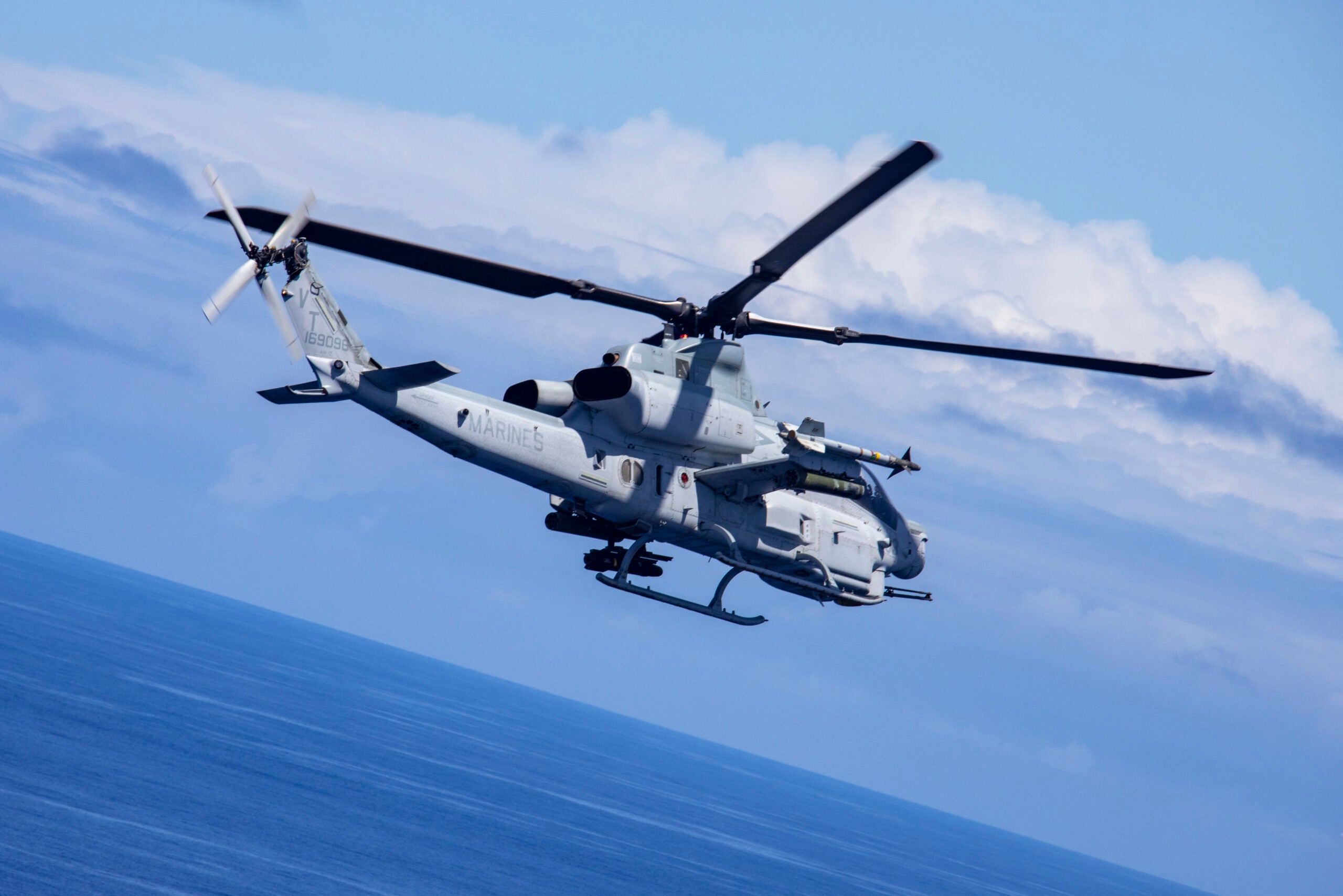 An AH-1Z Viper helicopter with Marine Light Attack Helicopter Squadron 367 conducts a training flight exercise, Marine Corps Base Hawaii, April 21, 2021. Marines with HMLA 367 worked in concert with Marine Medium Tiltrotor Squadron 268 and U.S. Navy Sailors with Helicopter Maritime Strike Squadron 37 to rehearse sea-denial operational scenarios. (U.S. Marine Corps photo by Sgt. Luke Kuennen)