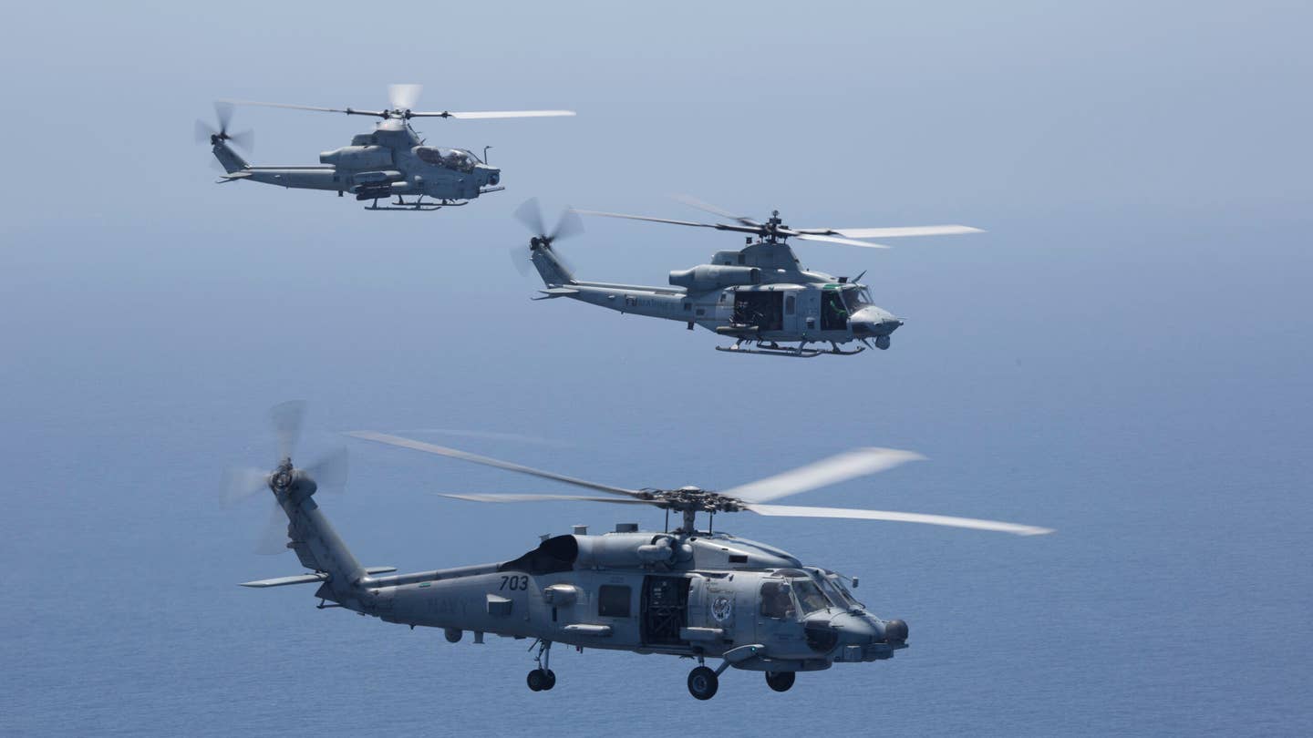 U.S. Navy MH-60R and U.S. Marine Corps aircraft from Marine Light Attack Helicopter Squadron (HMLA) 267, and HMLA-369, Marine Aircraft Group 39, 3rd Marine Aircraft Wing (MAW), drop sonobouys in the Pacific Ocean, July 20, 2021. (U.S. Marine Corps photo by Lance Cpl. Rachaelanne Woodward)