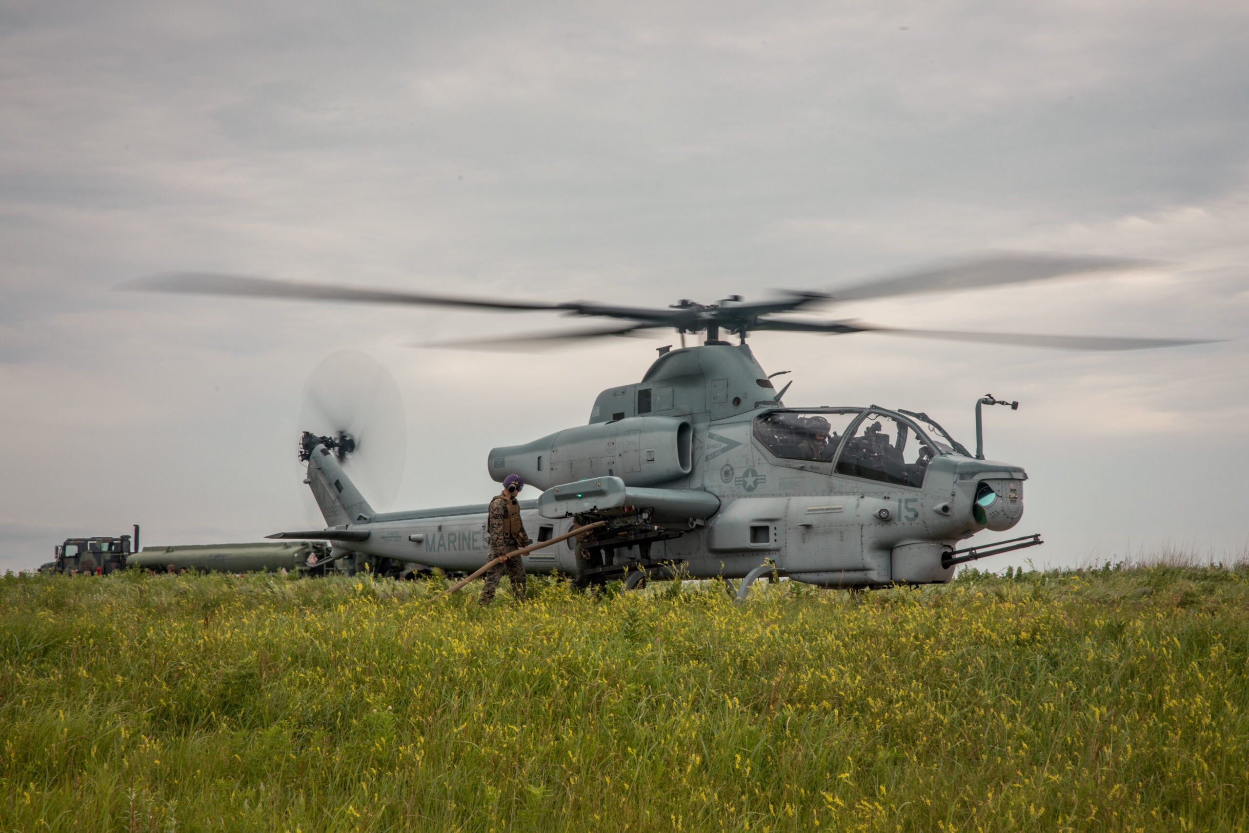 A U.S. Marine Corps AH-1Z Viper from Marine Light Attack Helicopter Squadron (HMLA) 773 Detachment A, 4th Marine Aircraft Wing, receives refueling within a Forward Arming and Refueling Point (FARP) at exercise Gunslinger 22 in Salina, Kansas, June 22, 2022. Exercise Gunslinger 22 is a joint exercise with the Kansas Air National Guard and U.S. Marine Corps designed to increase aircraft control and training for potential real-world contingencies. (U.S. Marine Corps photo by Lance Cpl. David Intriago)