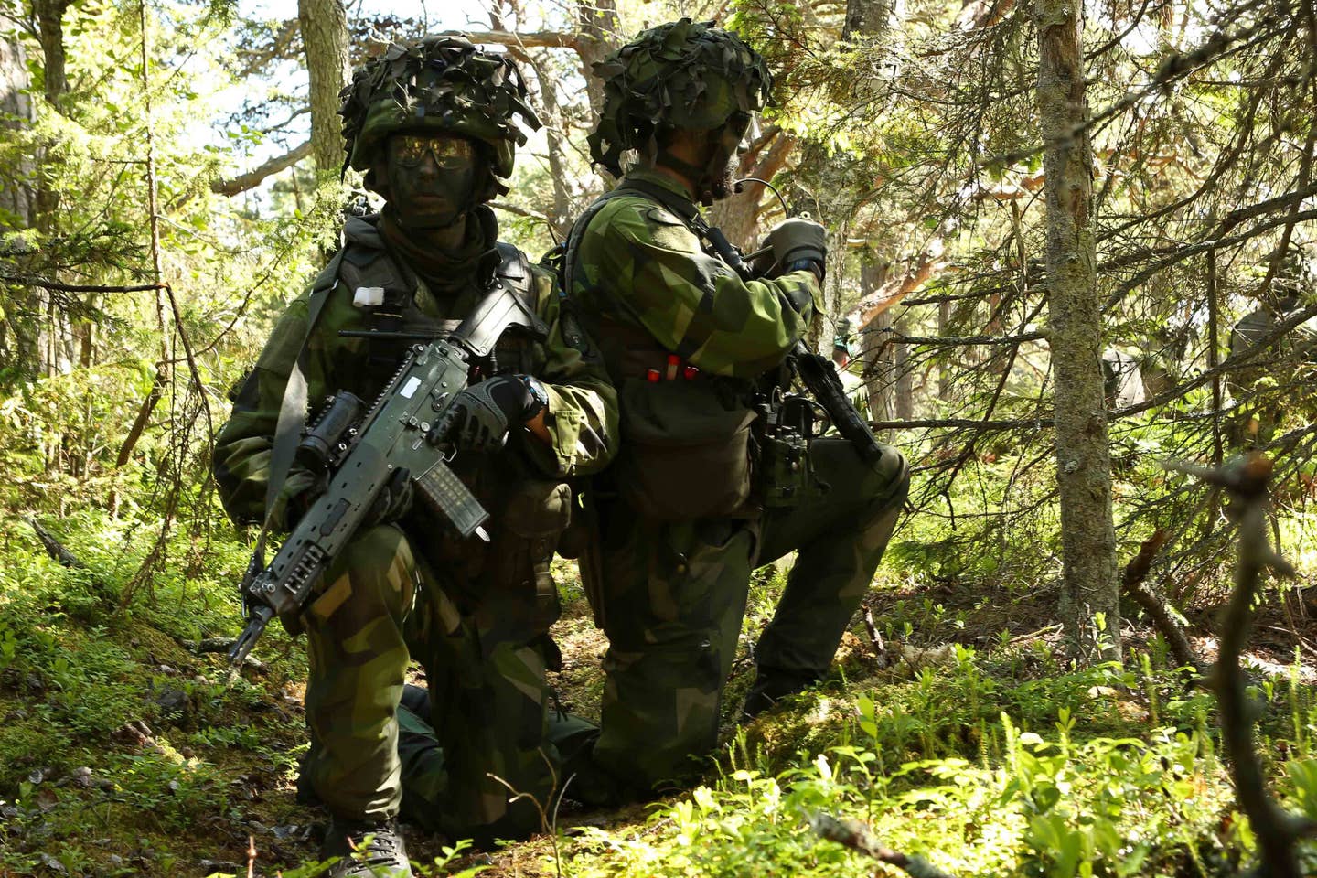 Swedish Marines on a reconnaissance exercise on the island of Uto, Sweden, armed with AK 5 assault rifles. <em>U.S. Navy photo by Mass Communication Specialist 1st Class America A. Henry/ Released</em>