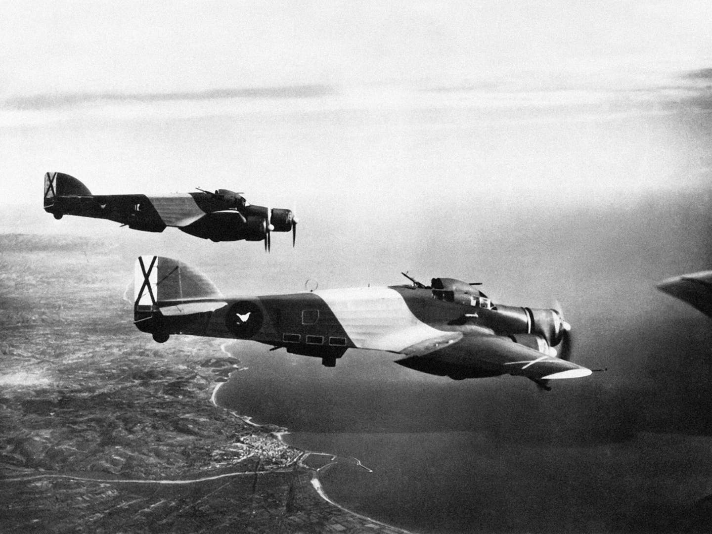 Italian Savoia-Marchetti SM.79 medium bombers flying over Tarragona in southern Spain in the service of Franco’s Nationalist forces, 1937. <em>Pictures From History/Universal Images Group via Getty Images</em><br>