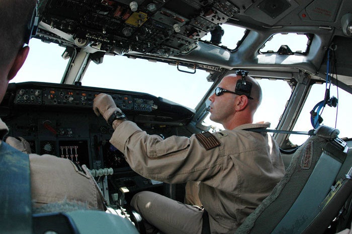 Navy Lt j.g. Nathan Lassas enters information into the autopilot computer in July in Southwest Asia. Lieutenant Lassas, assigned to Task Force 124, pilots an E-6B Mercury over Iraq which helps Soldiers communicate on the ground. (U.S. Air Force photo/Staff Sgt. Cassandra Locke)