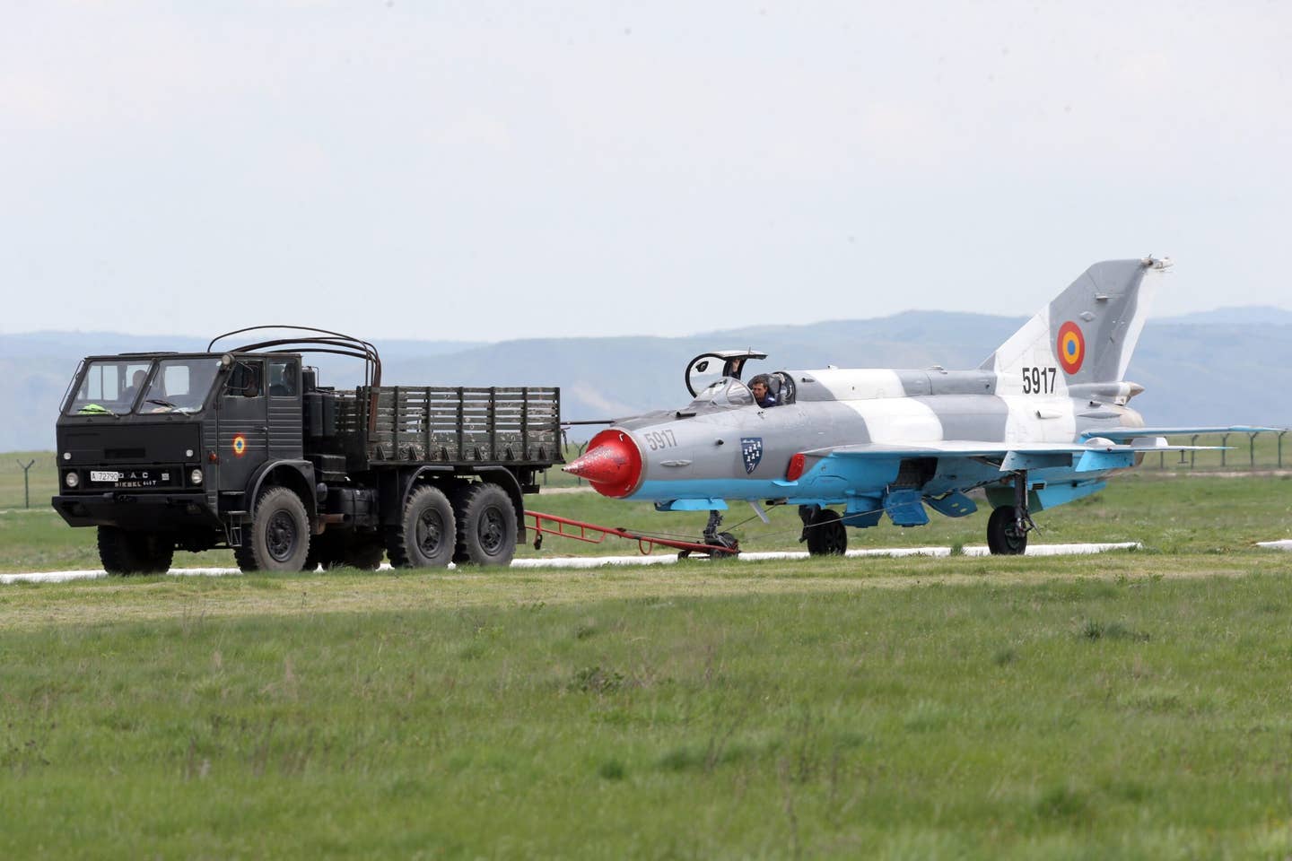 Romanian Air Force ground crew move a MiG-21 LanceR at the 71st Air Base in Campia Turzii, Romania, in April 2014. <em>MIRCEA ROSCA/AFP via Getty Images</em>
