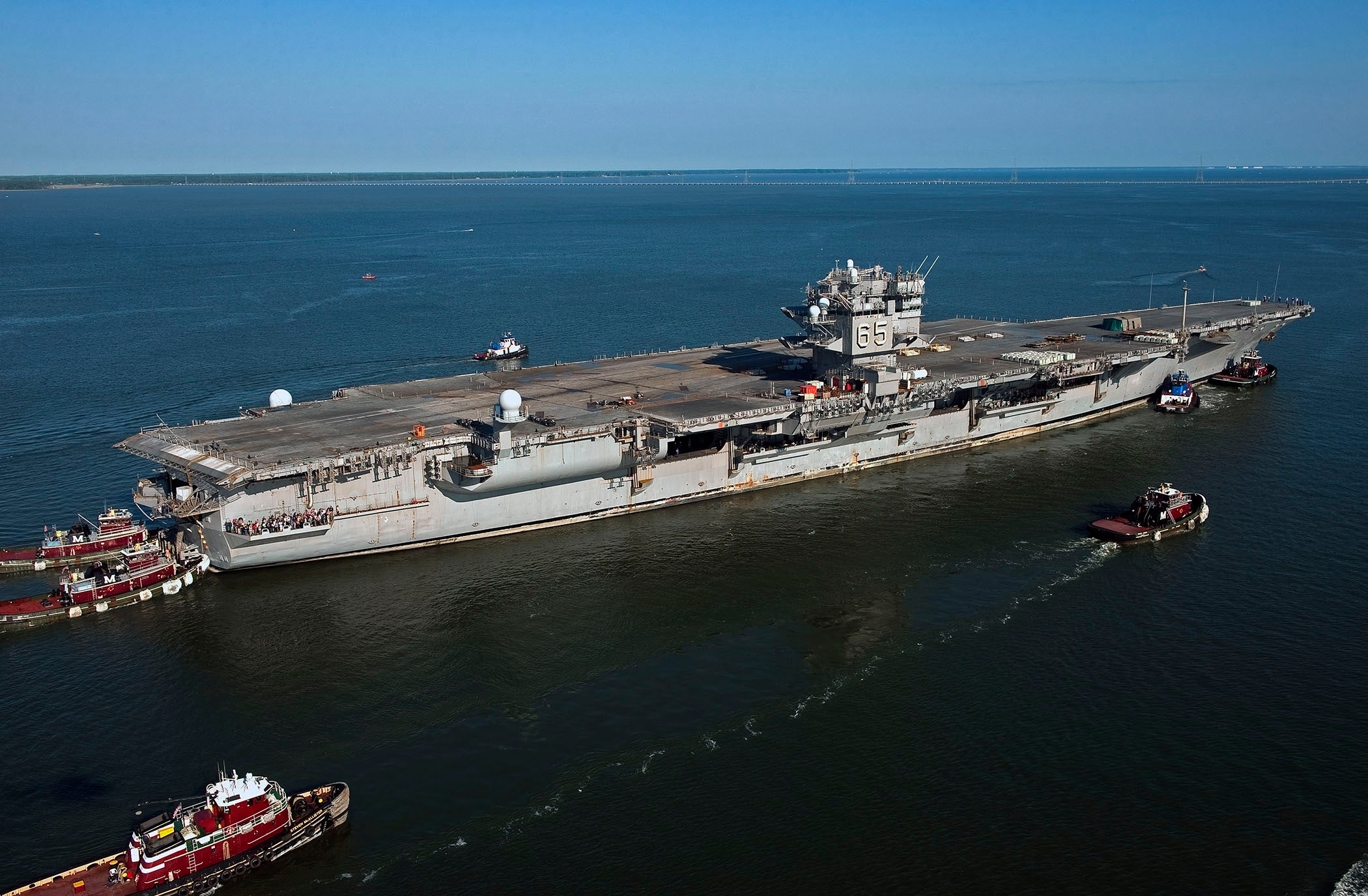 The aircraft carrier USS Enterprise (CVN 65) makes its final voyage to Newport News Shipbuilding. The first nuclear-powered aircraft carrier will be dismantled at the shipyard prior to the scheduled commissioning of the next aircraft carrier Enterprise (CVN 80). (U.S. Navy photo courtesy of Huntington Ingalls Industries by John Whalen/Released)