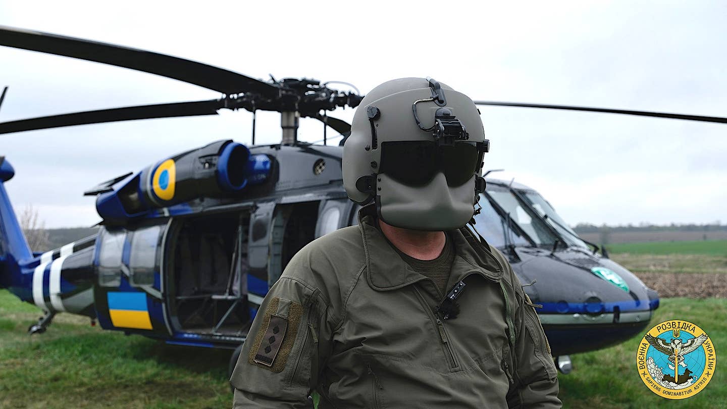 A crew member poses in front of one of the GUR UH-60 Black Hawks. <em>Ukrainian Main Directorate of Intelligence</em>